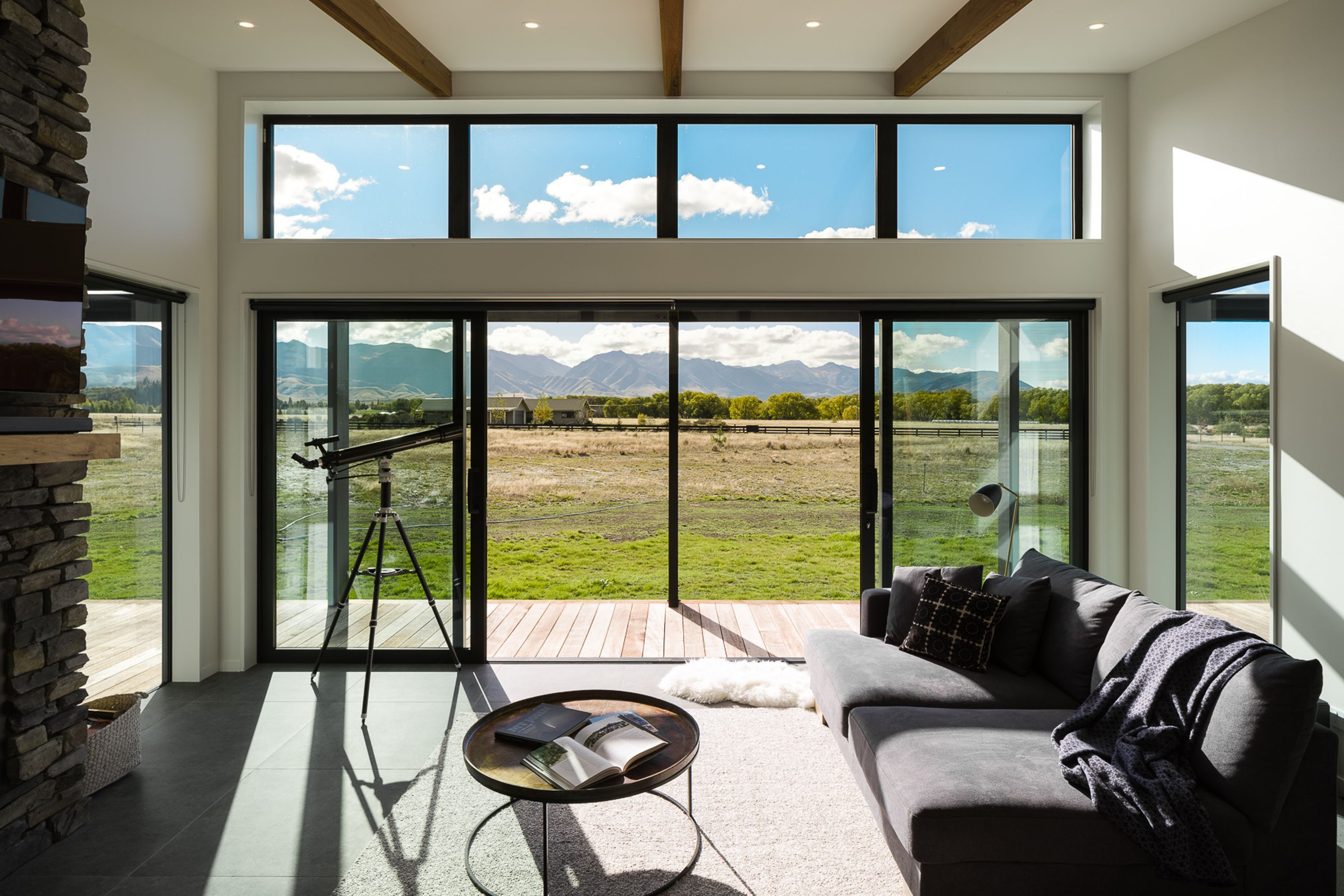 Floor to ceiling glazing and large sliding doors to the north elevation allow the house to be opened up, maximising potential for natural light and ventilation and creating a strong visual to the mountain landscape.