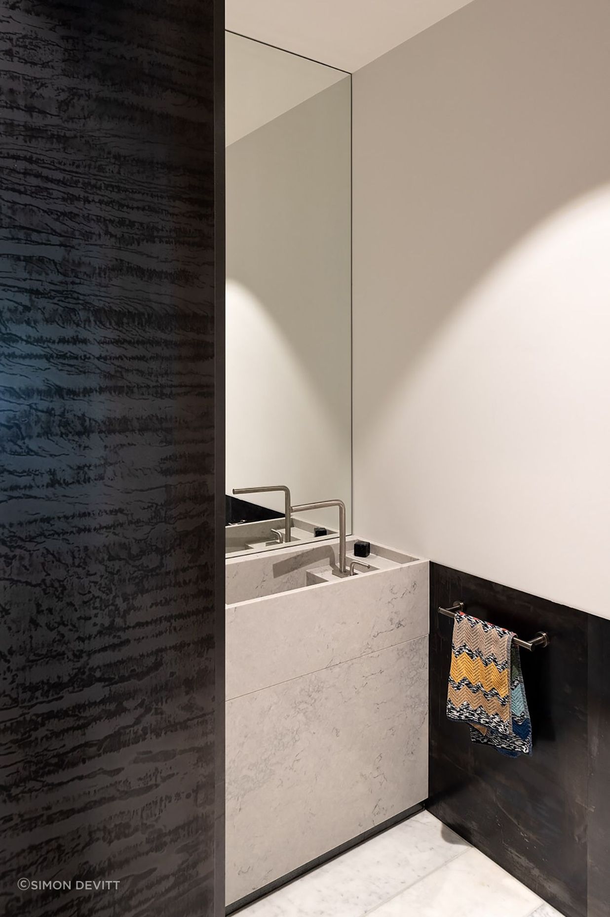 Again, the bathroom surfaces play with light and dark, smooth and textural.