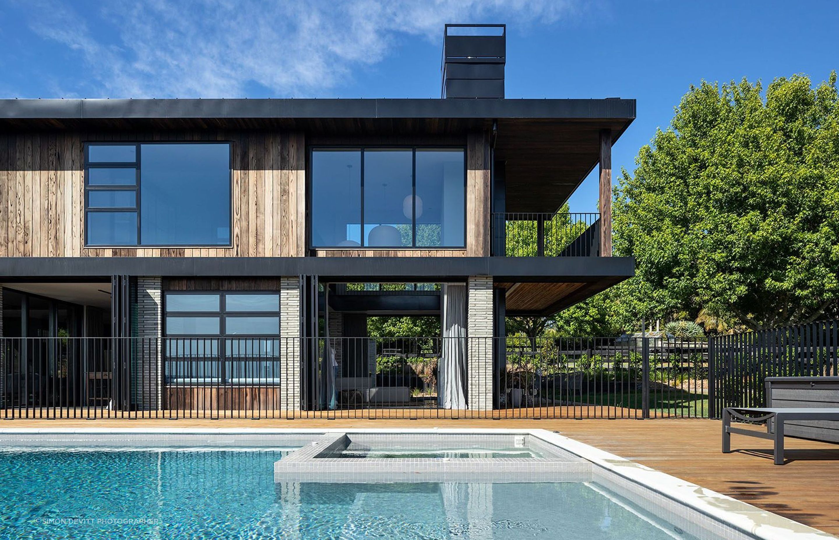 An infinity pool stretches out in front of the house, further affirming the directional gaze and connection with this rural coastal landscape.