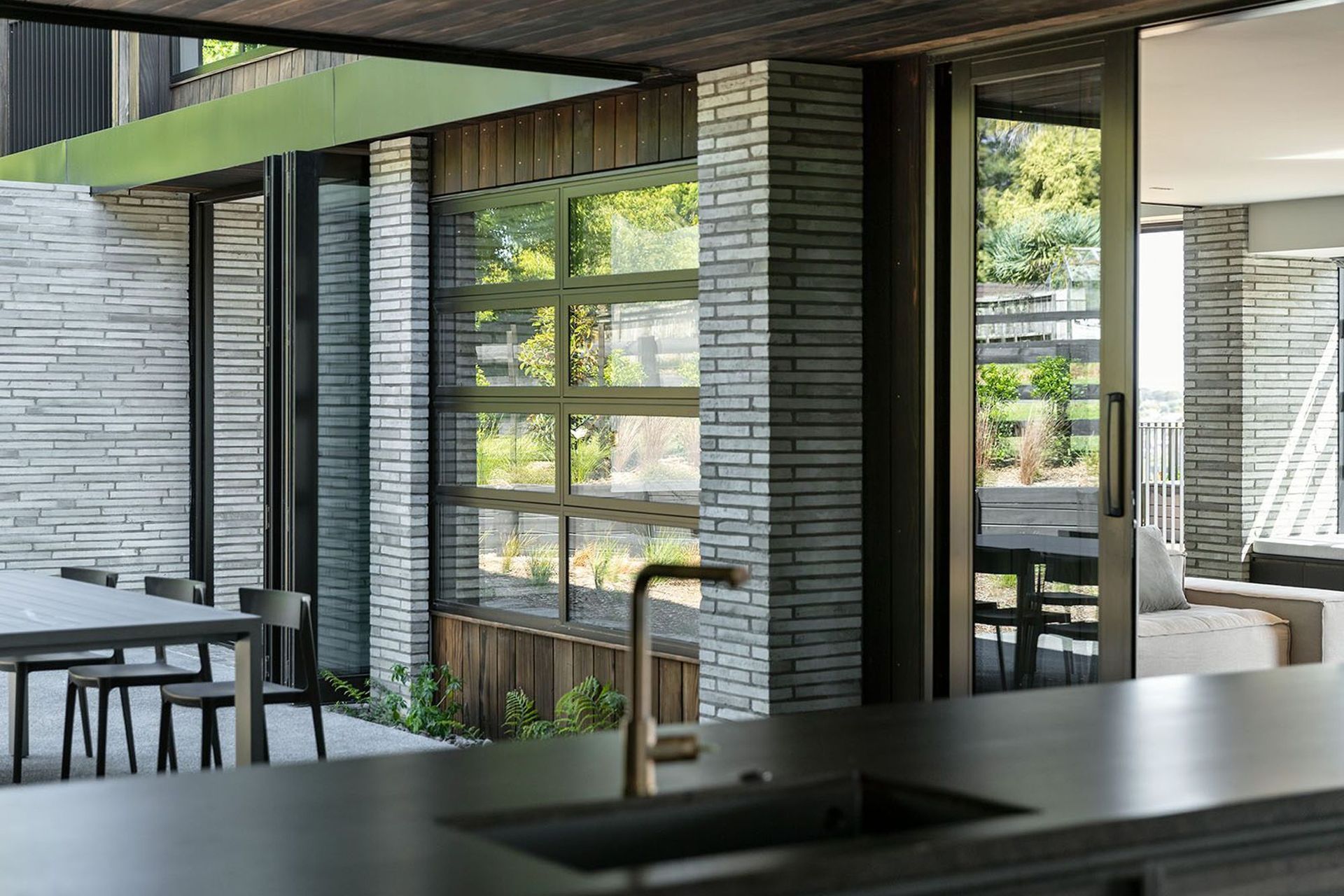 A sheltered central courtyard is protected from the elements by the lower pavilion that wraps around it.