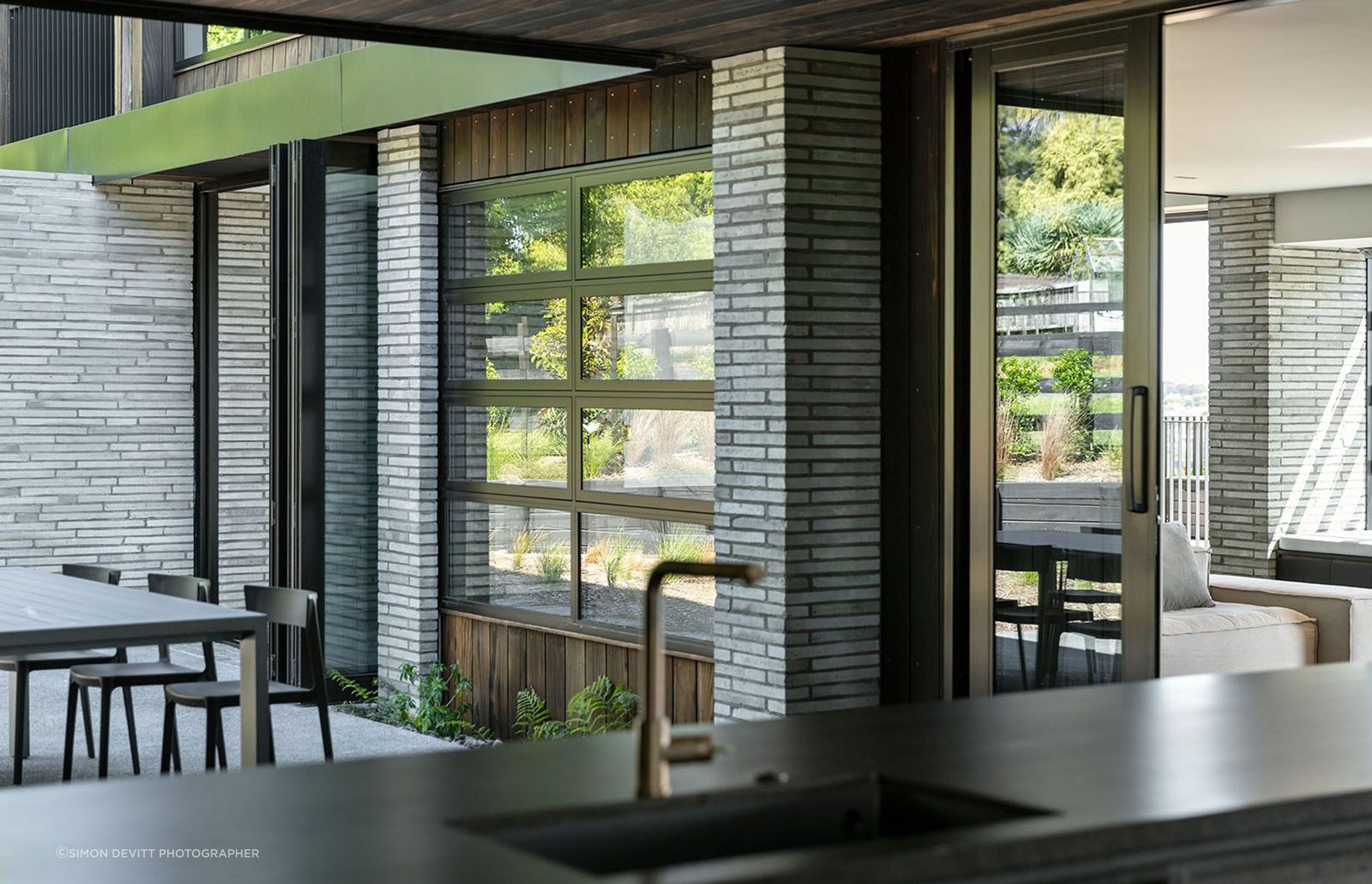 A sheltered central courtyard is protected from the elements by the lower pavilion that wraps around it.