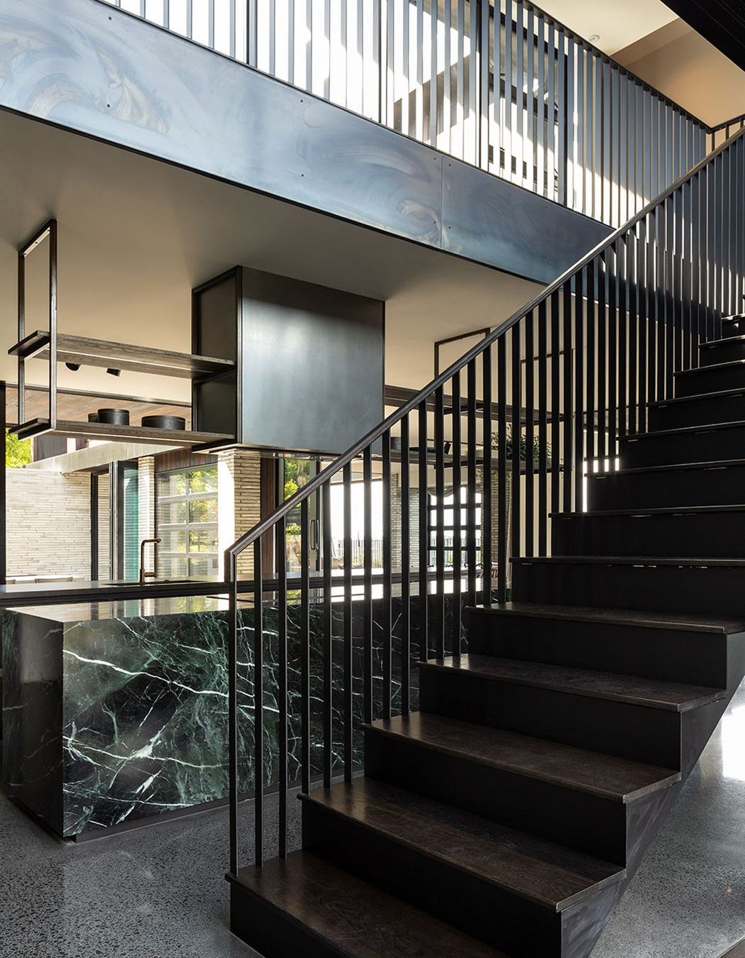 A striking steel balustrade leads to the upper pavilion that houses the private areas of the house.