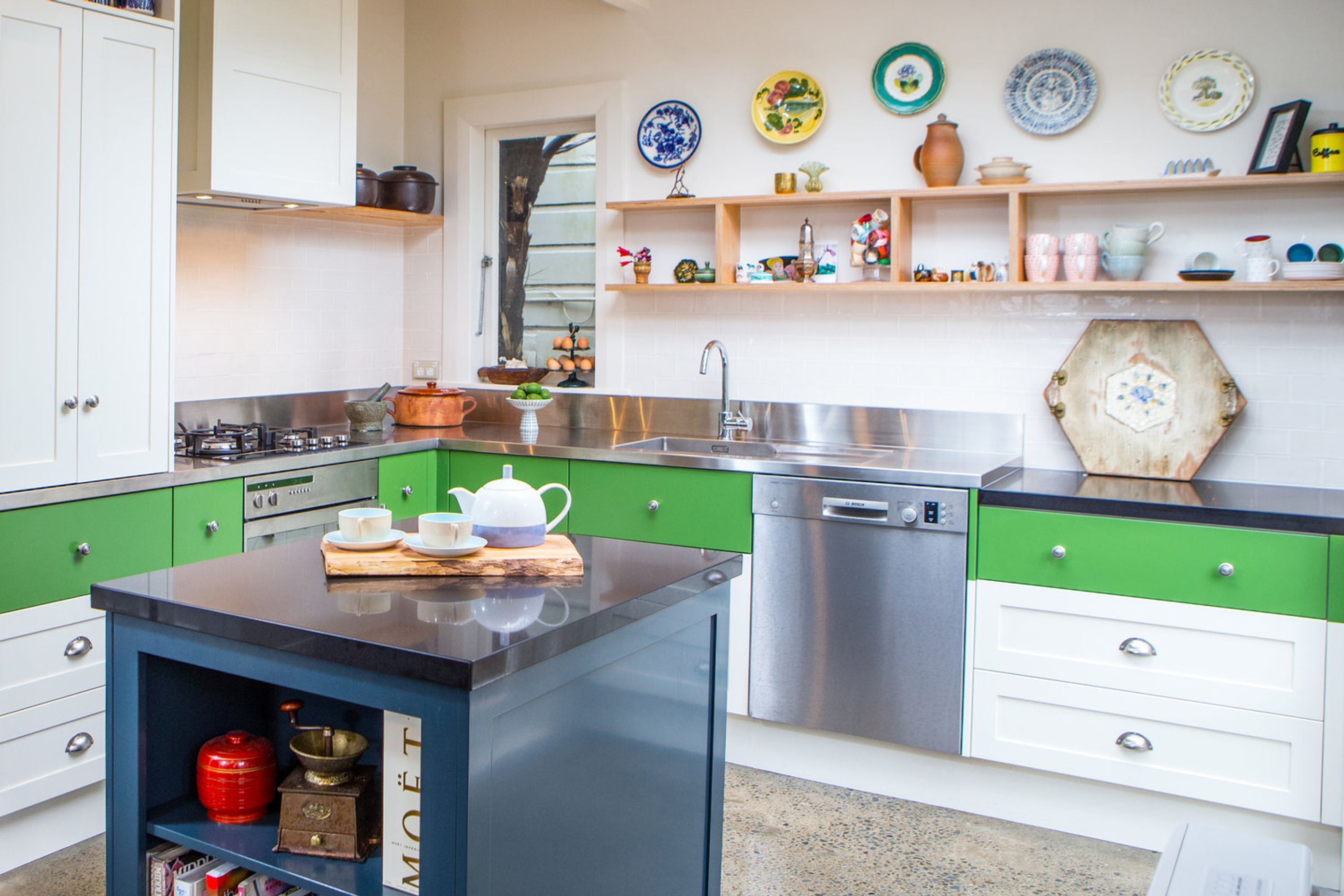 The stainless steel bench wraps the kitchen, then a dropped down stone bench allows for a better workspace for making pastry.