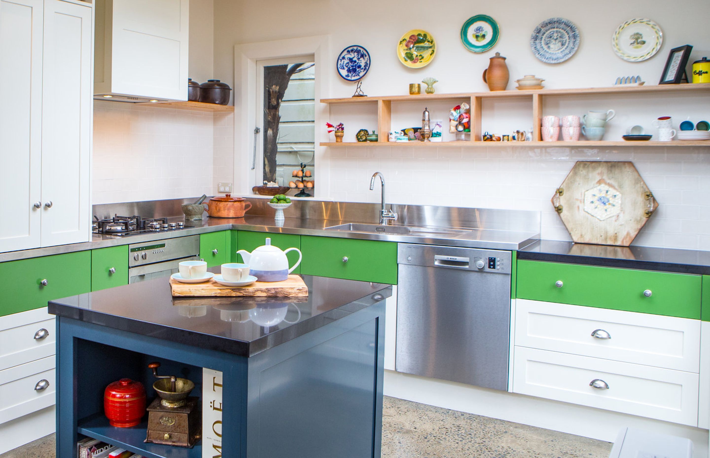 The stainless steel bench wraps the kitchen, then a dropped down stone bench allows for a better workspace for making pastry.