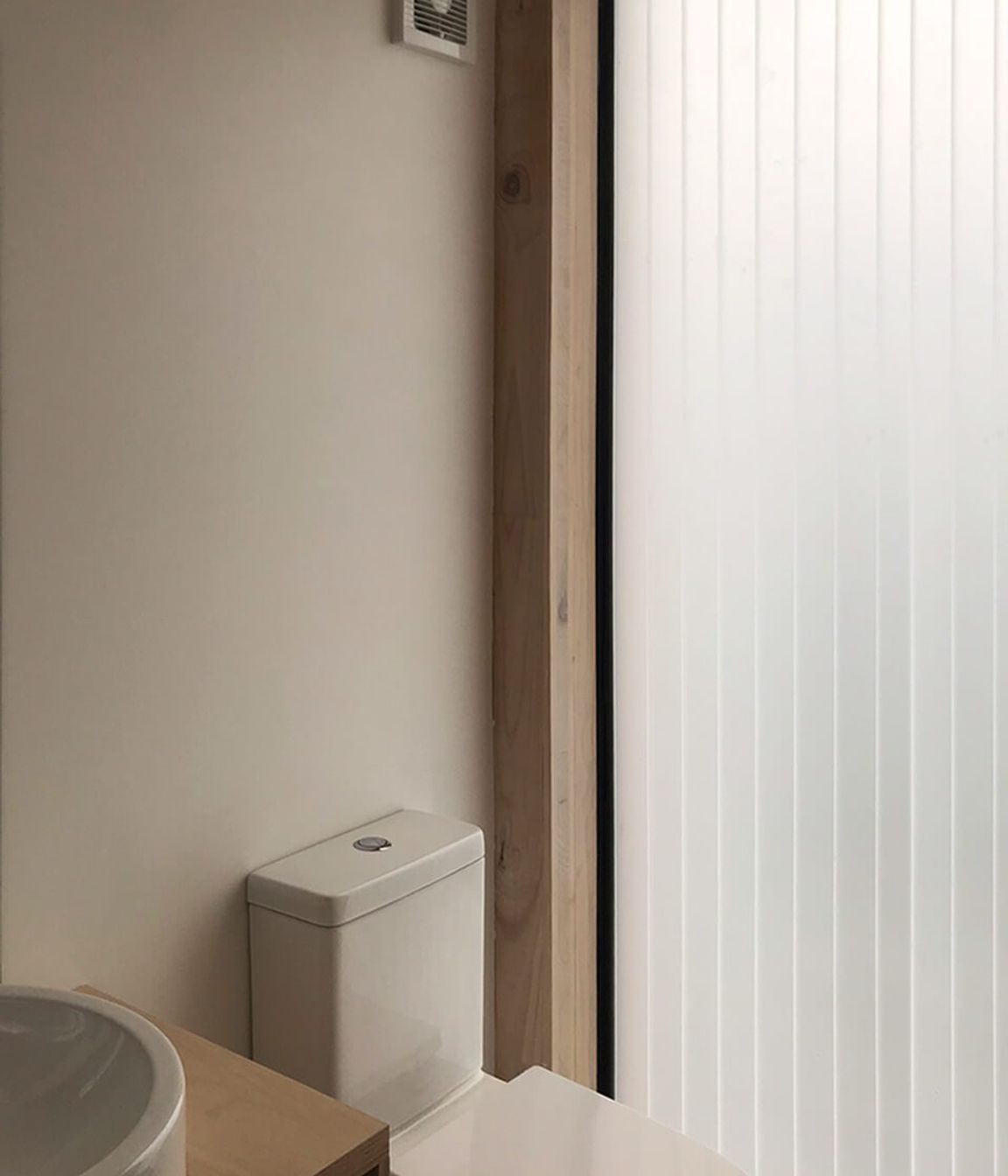 A polycarbonate slot in the wall fills the bathroom with light.