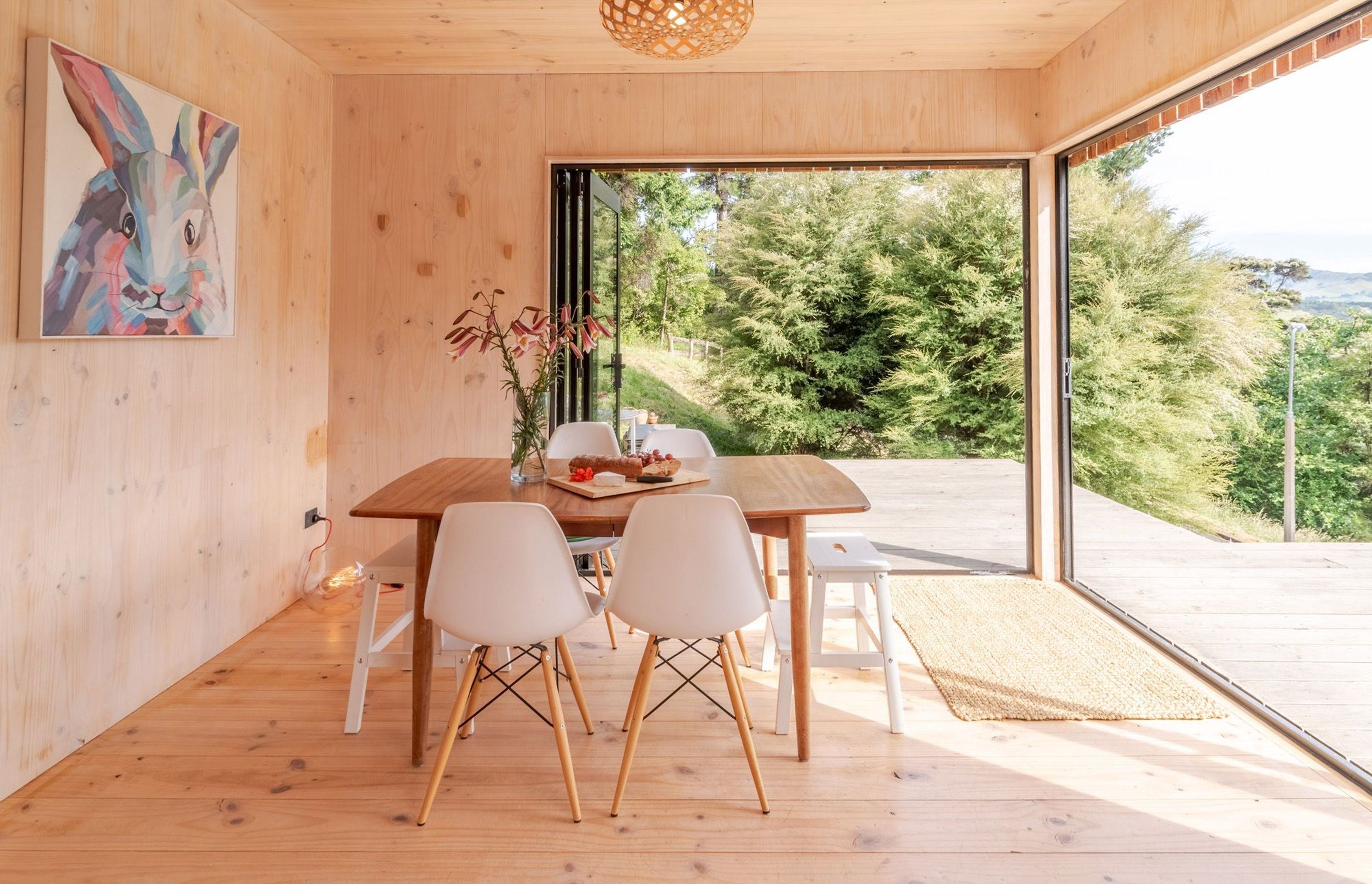 The structural CLT walls are painted with a white wash, creating a contrast with the flooring.