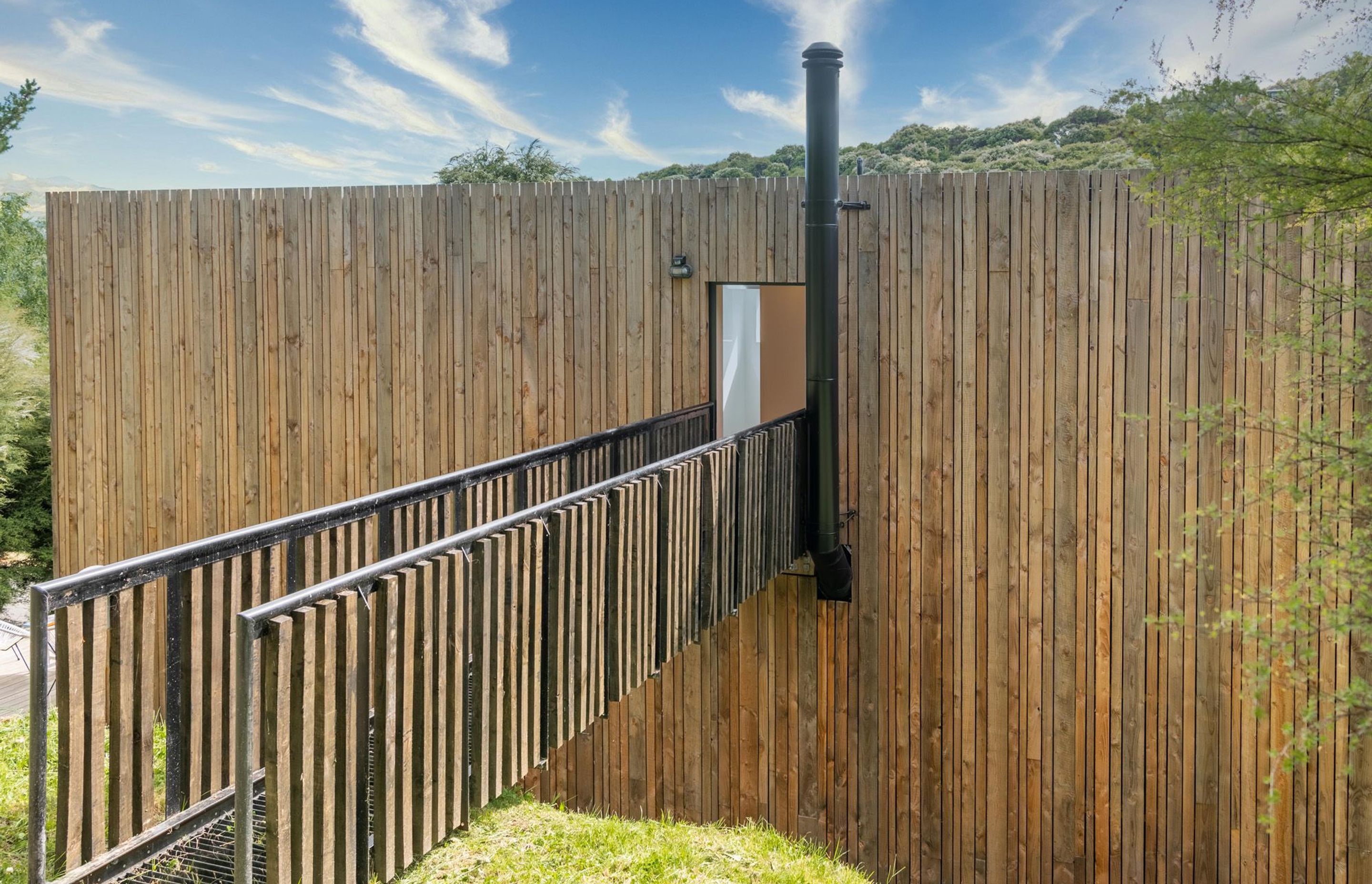 The chimney from the ground-floor fireplace has been neatly lined up with the bridge insertion into the house.