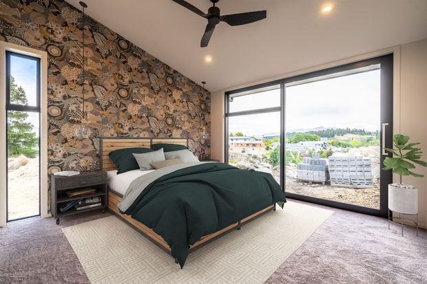 A contemporary bedroom with a low timber bed, dark teal bedding, and a textured patterned feature wall. Floor-to-ceiling glazing provides expansive views, while a black ceiling fan, recessed lighting, neutral carpet, and a light area rug complete the room.