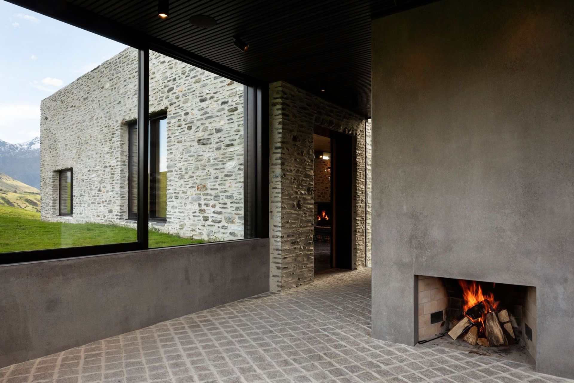 The 'glasshouse' is a cosy yet ambiguous living space with operable glass on three sides to provide an inside/outside quality and views around the surrounding landscape.