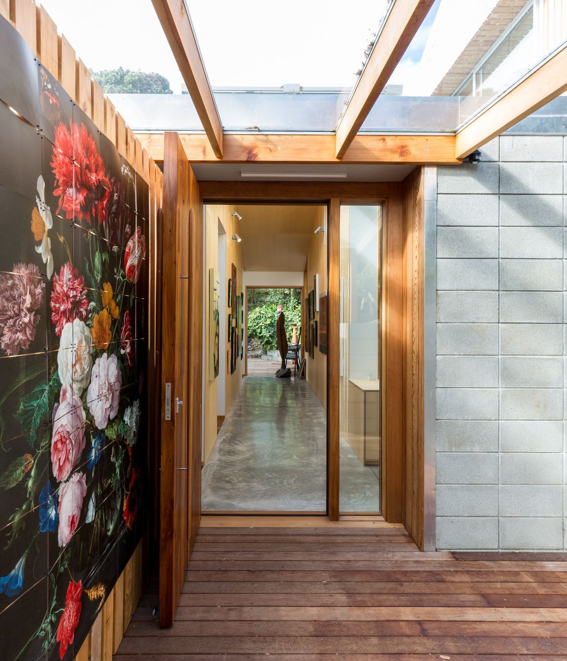 The new, covered entryway, which links the original cottage to the extension, features a reproduction of a Jan van Huysum still life.