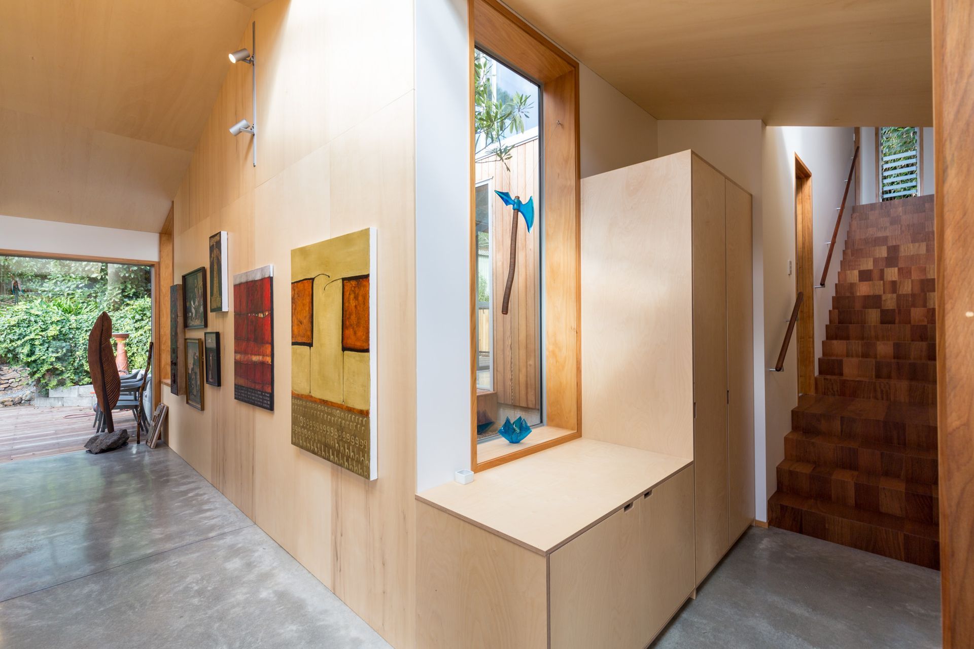The stairs of the extension lead up to a living area on the ground level and a master bedroom on the upper level.