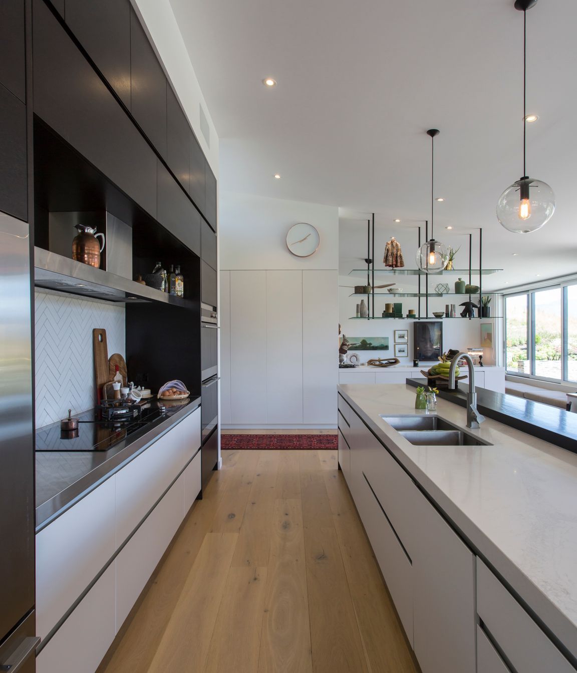 Handleless cabinetry and integrated appliances keep the working heart of the kitchen sleek and unobtrusive.