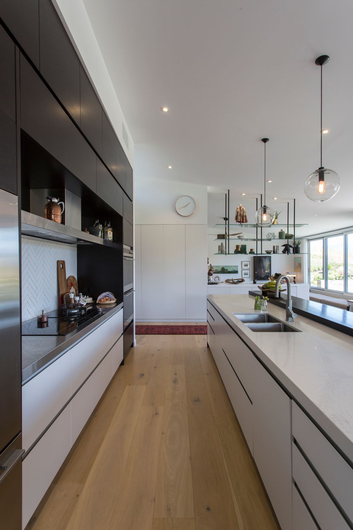 Handleless cabinetry and integrated appliances keep the working heart of the kitchen sleek and unobtrusive.