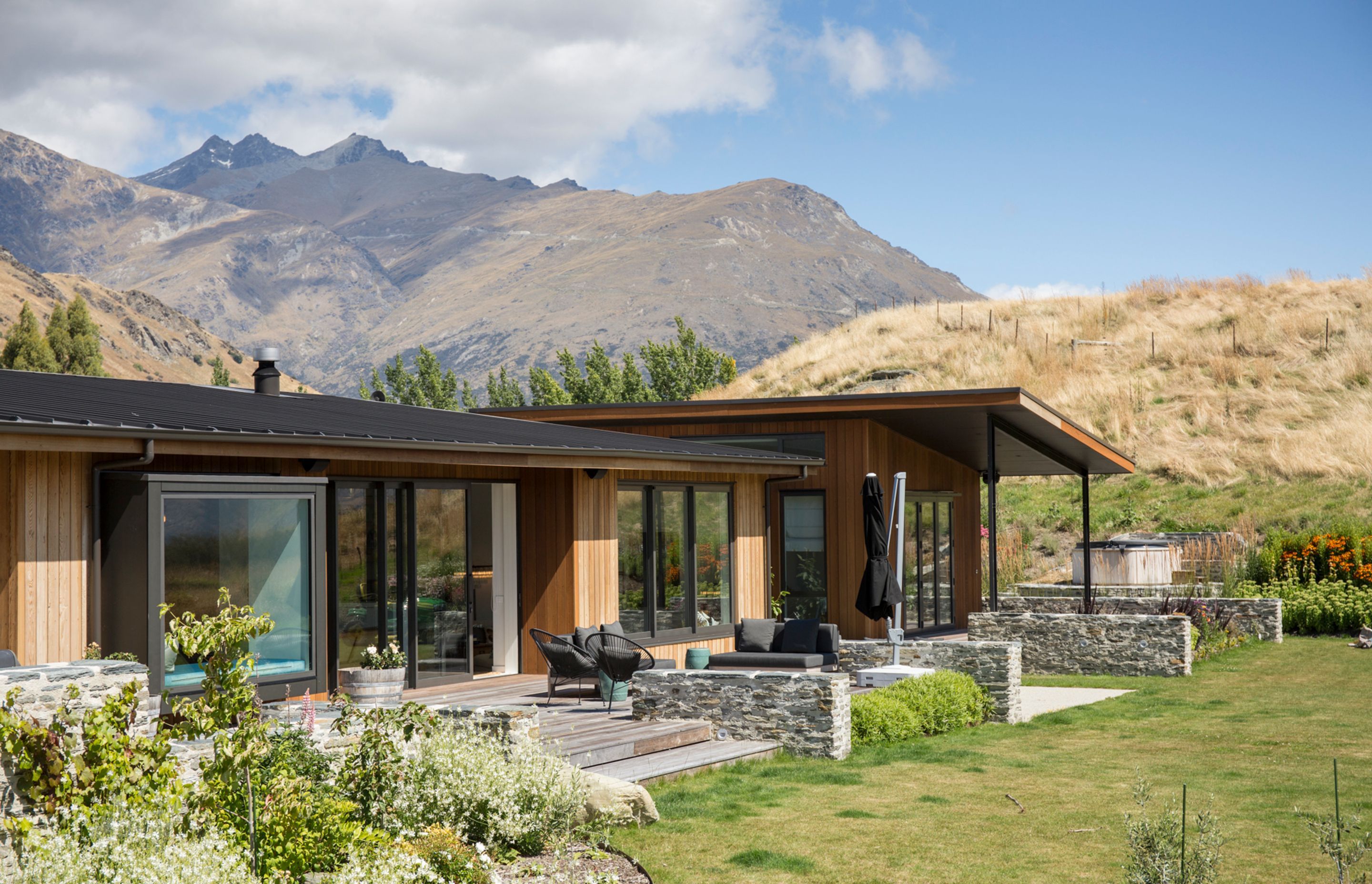 All of the primary rooms, including the main bedroom, lead out onto decked areas, establishing an easy relationship between the house and its surroundings.