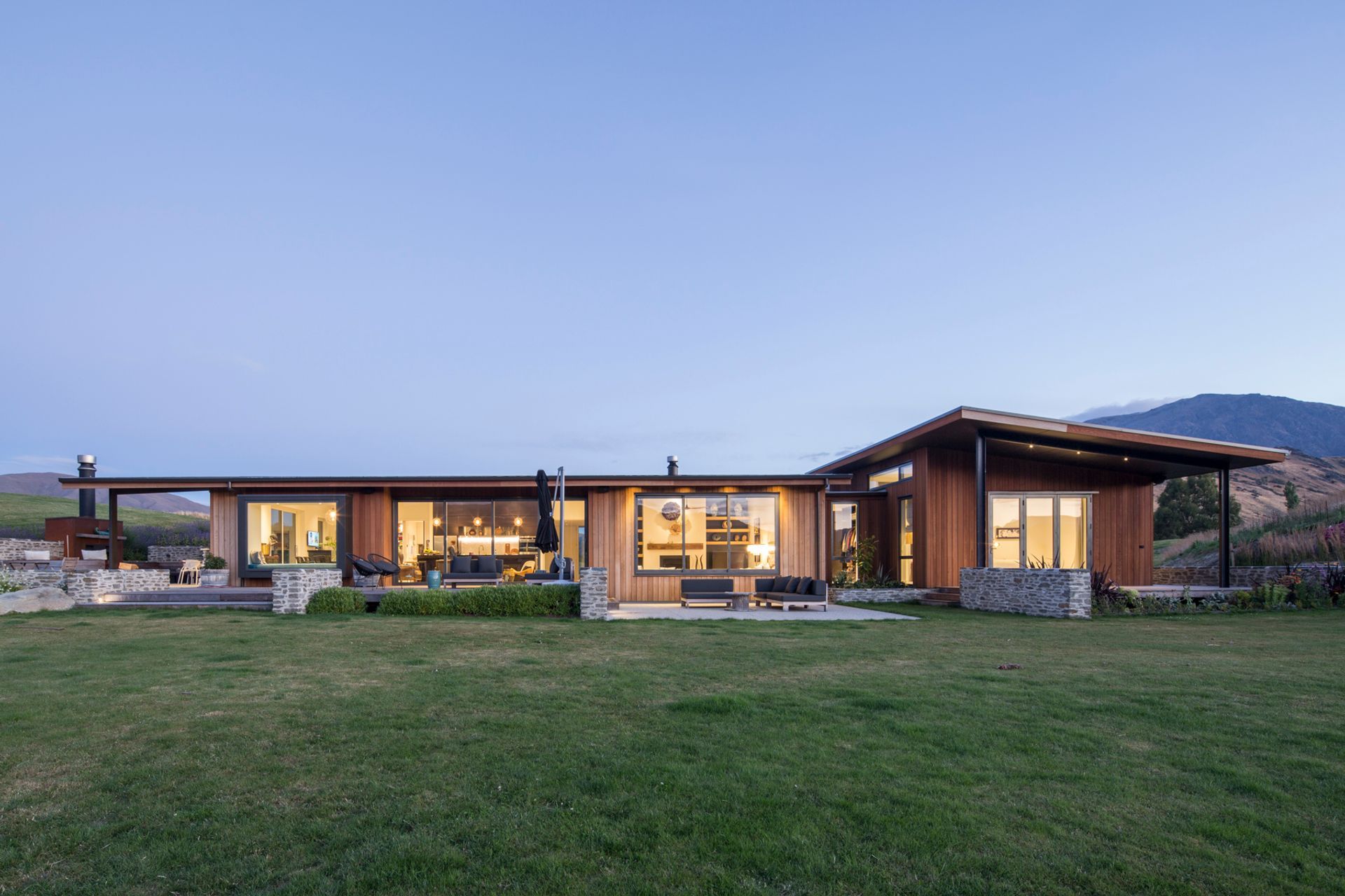 Stone and timber accents add warmth and texture to the exterior scheme and help in keeping the house unobtrusive in the broader landscape.