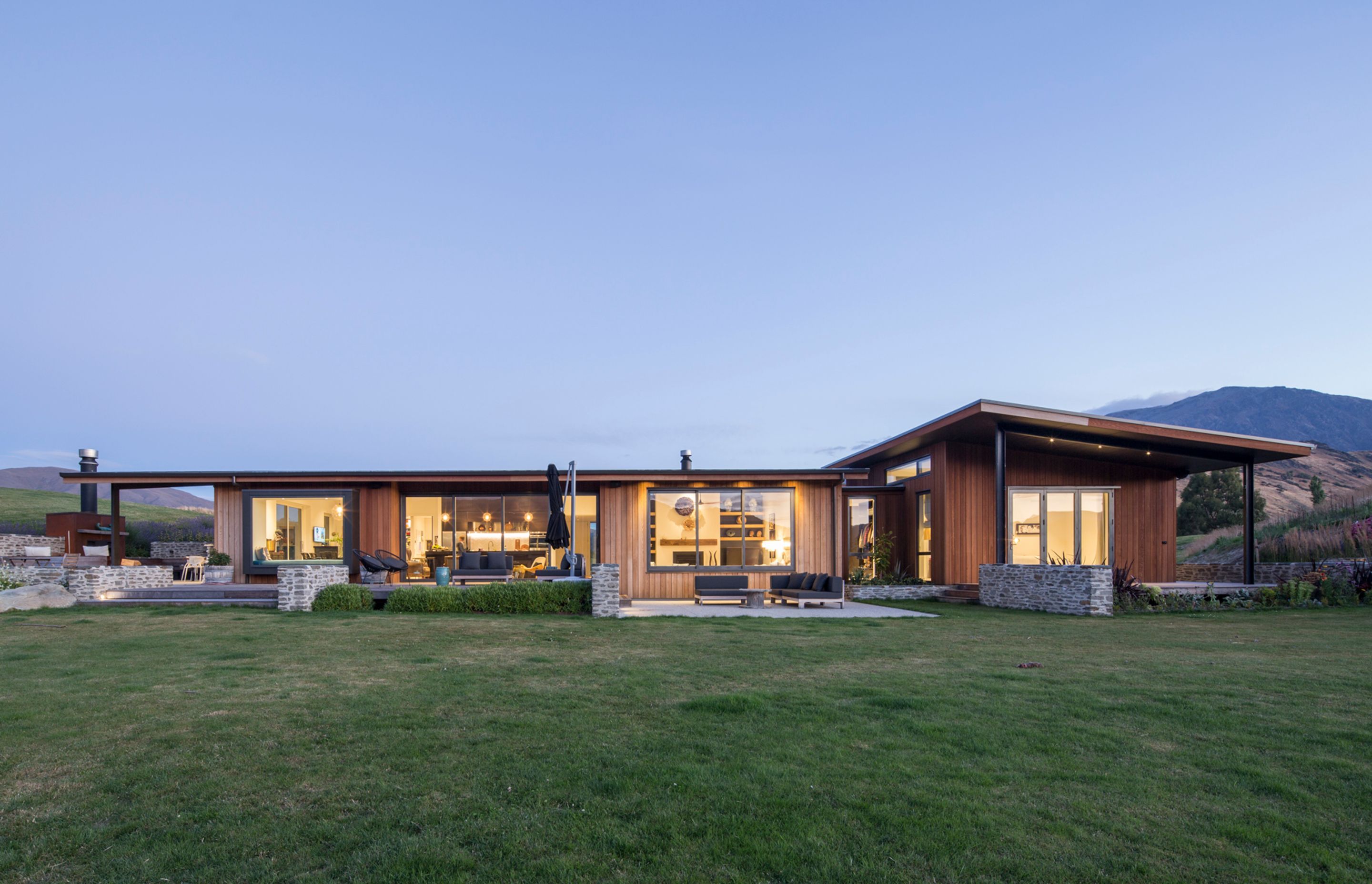 Stone and timber accents add warmth and texture to the exterior scheme and help in keeping the house unobtrusive in the broader landscape.