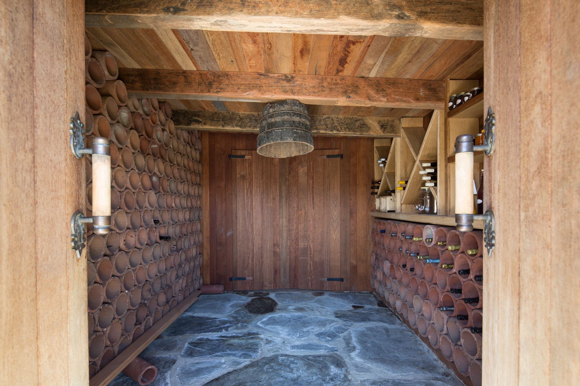 Perfectly insulated, the wine cellar nestles back into a natural outcropping.