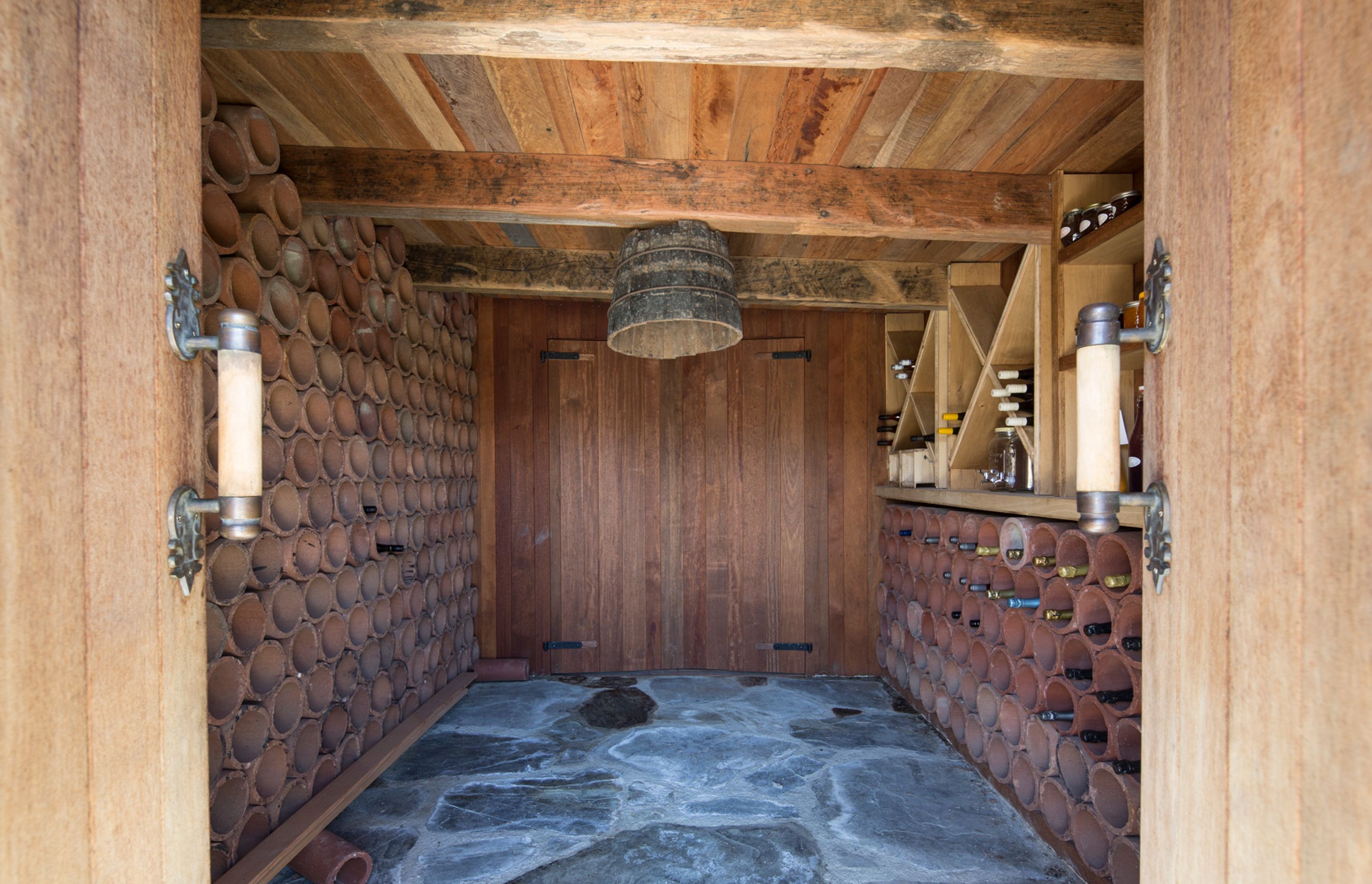 Perfectly insulated, the wine cellar nestles back into a natural outcropping.