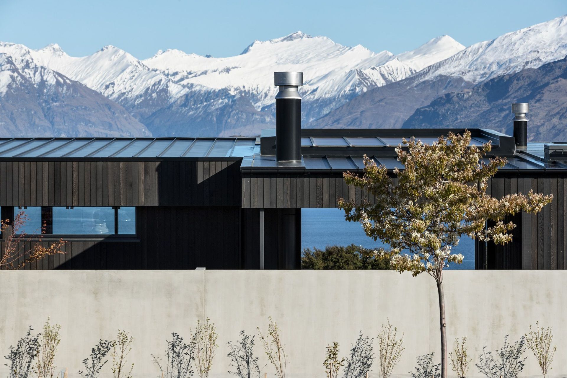 The site is accessed from a cul de sac with neighbouring properties to the south, east and north, and stunning lake and mountain to the west. 