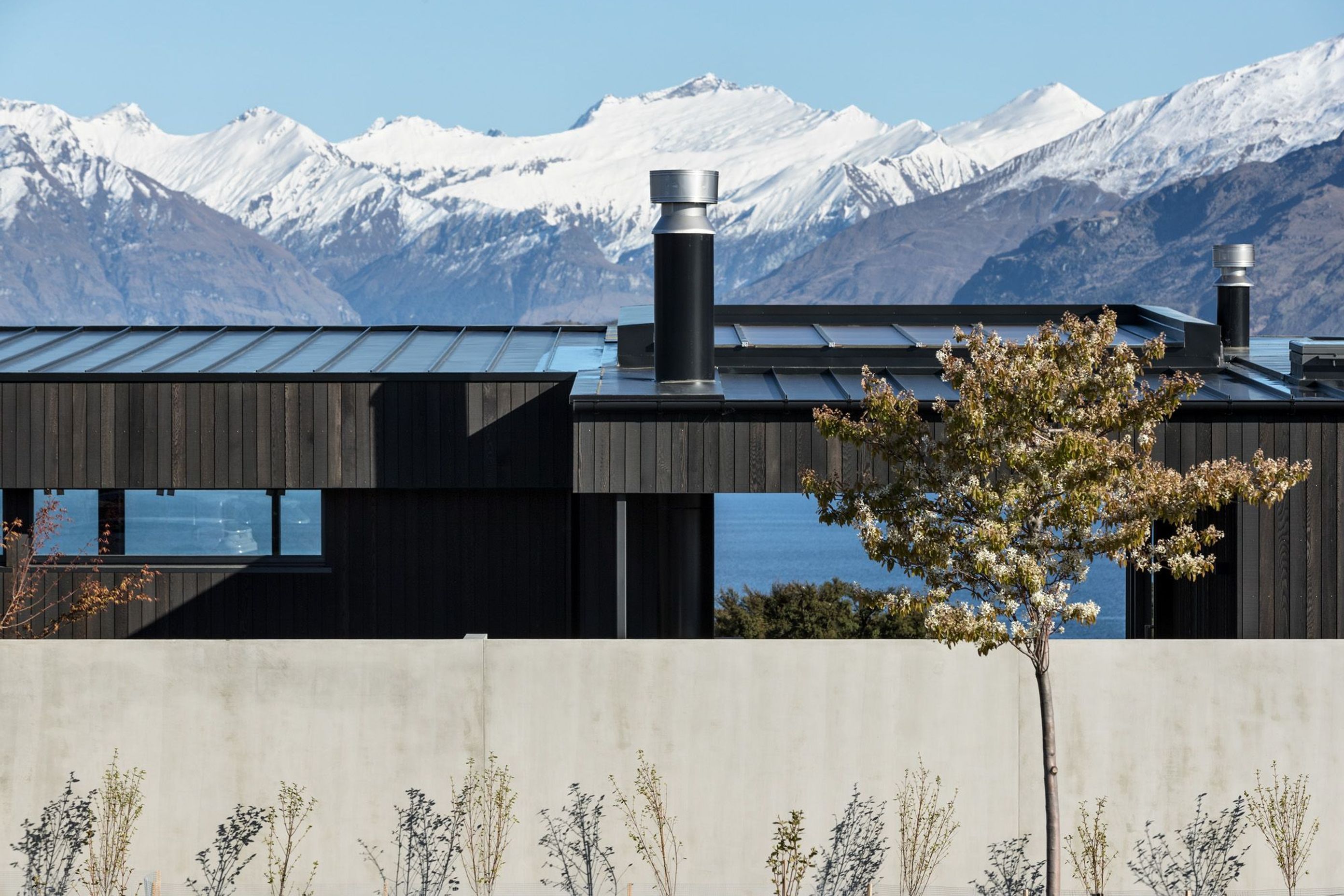 The site is accessed from a cul de sac with neighbouring properties to the south, east and north, and stunning lake and mountain to the west. 
