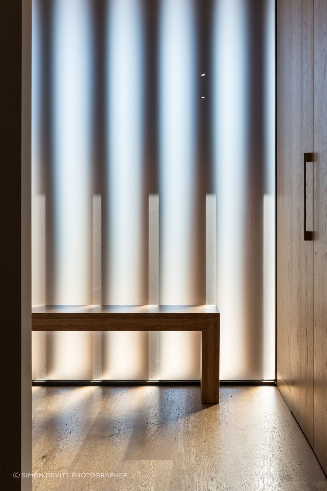 Inside the front entrance, looking through the frosted glazing and vertical louvres.