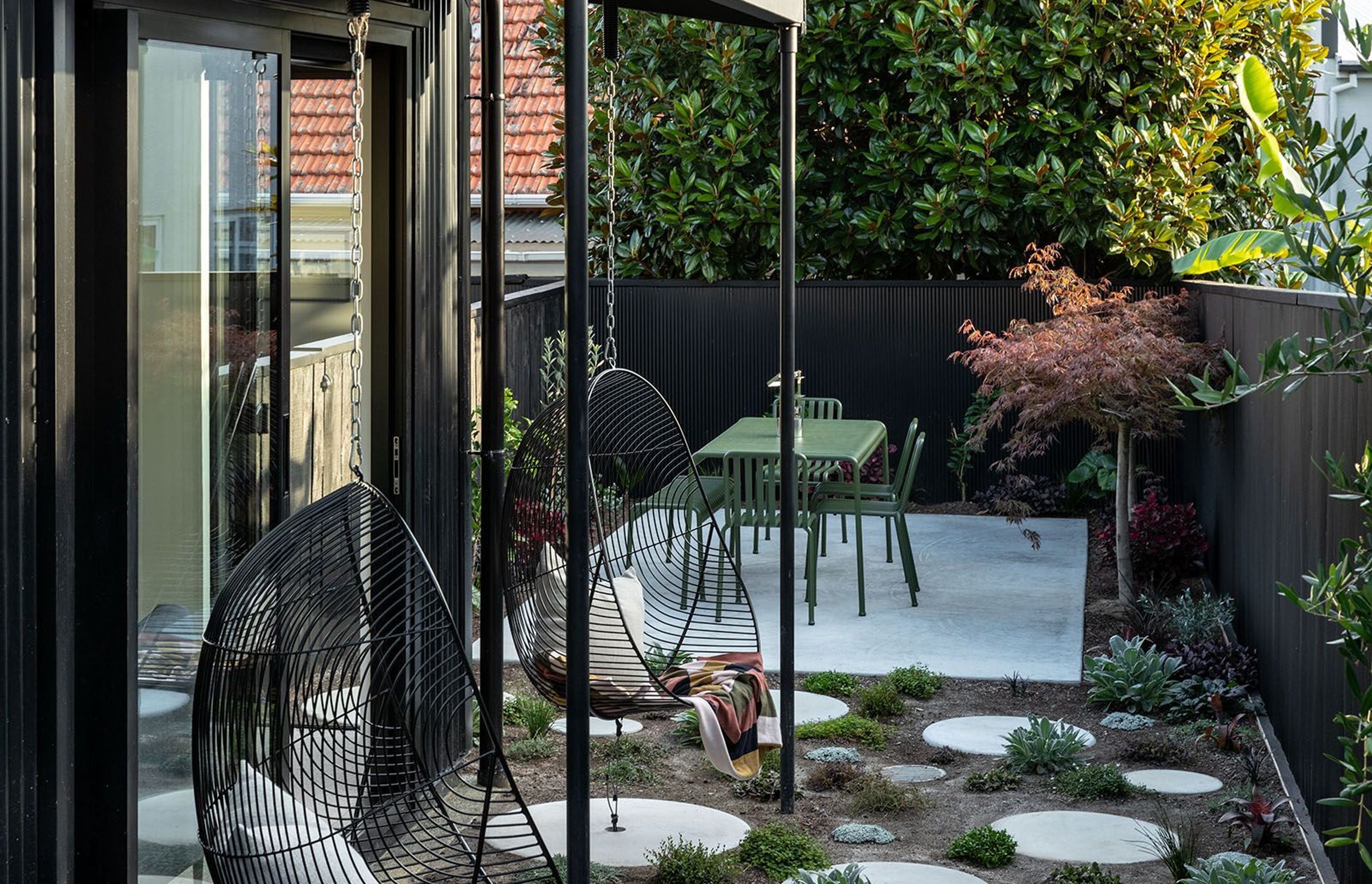 A courtyard garden that's not a courtyard garden by treating the fence like a wall of the house.