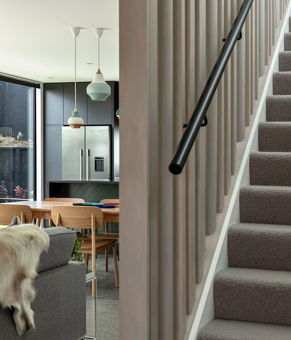 Lighly-stained vertical timber balastrades help to draw light into the living space.