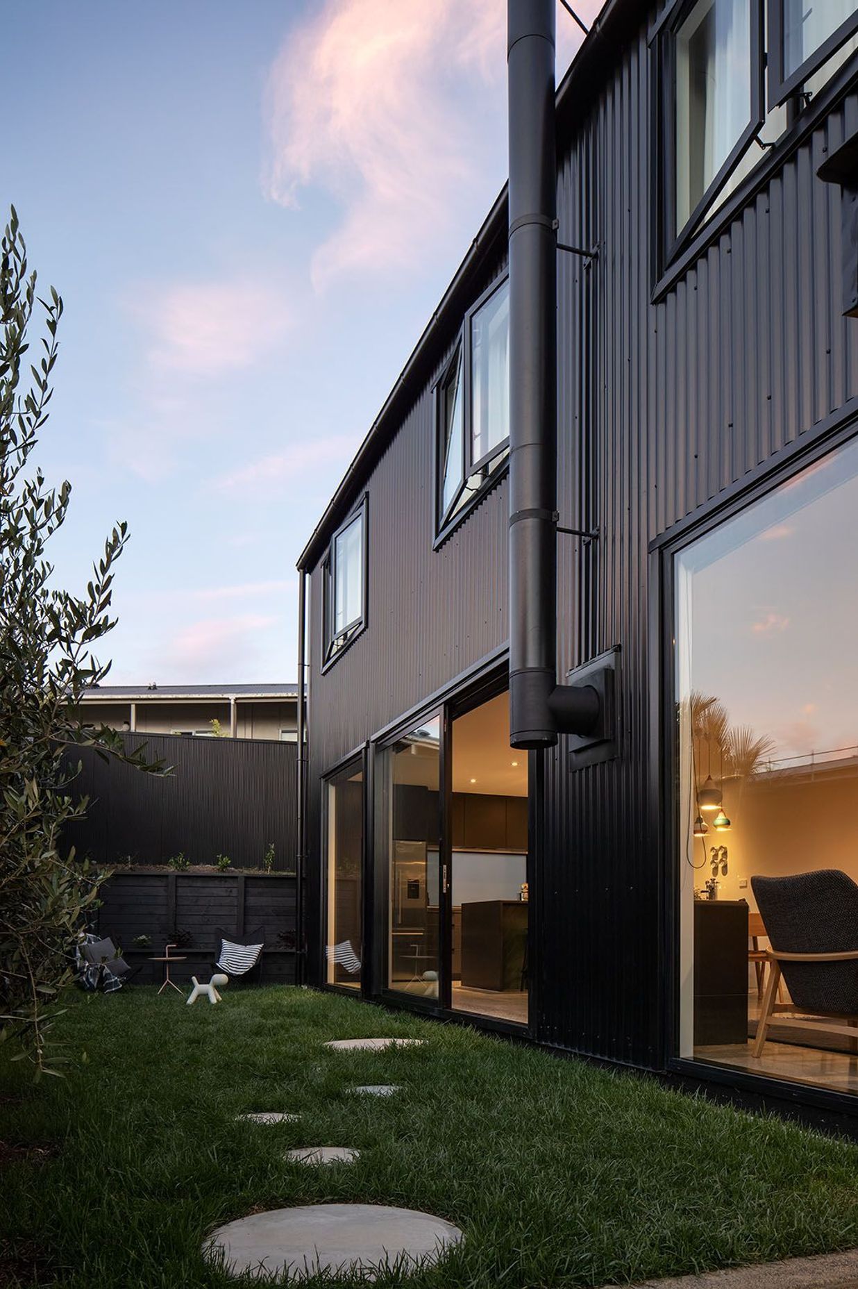 The side of the house connects with the ground-floor spaces.