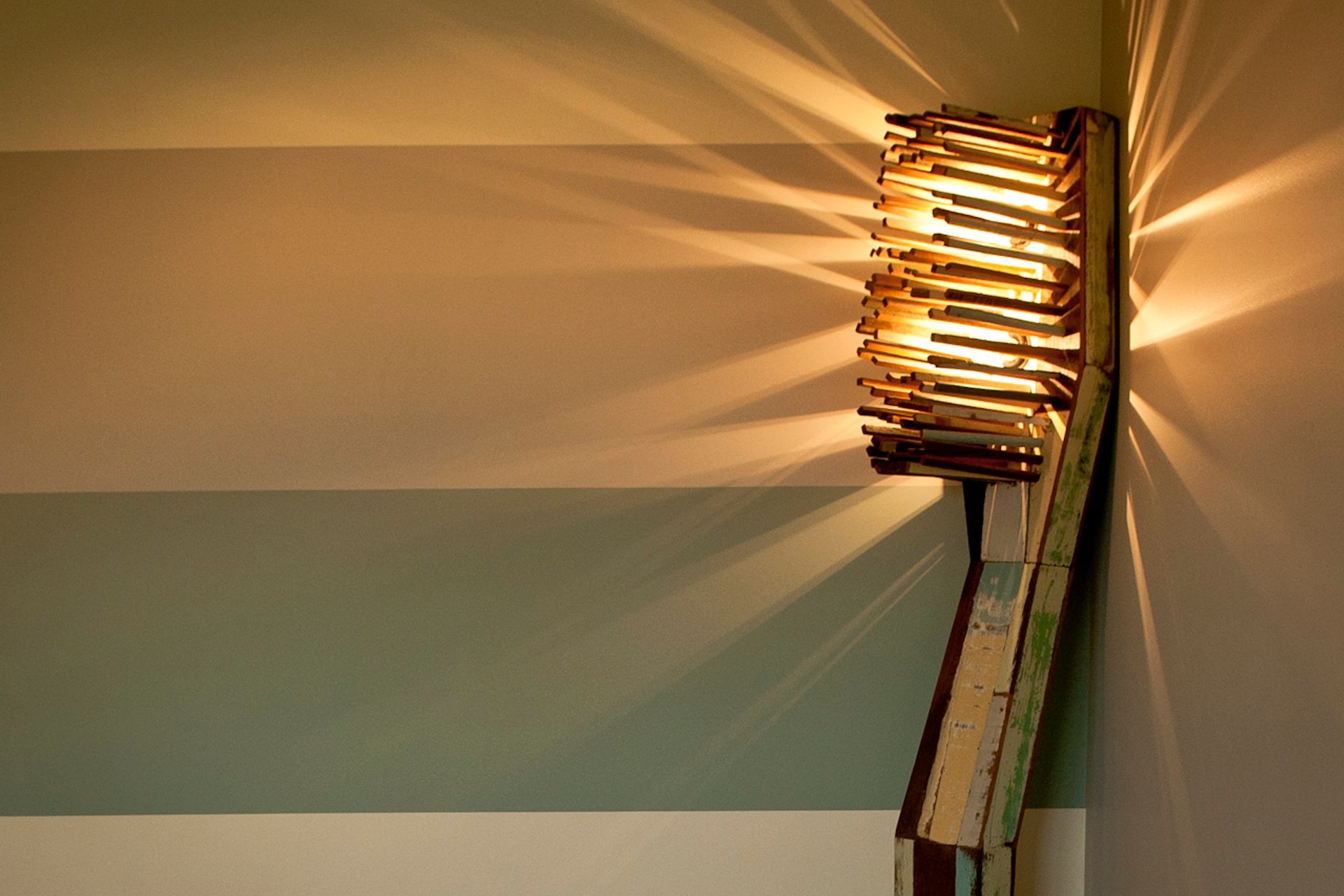The colours in the Toothbrush standard lamp are painted in stripes on the walls that lead down the two hallways to the main surgery