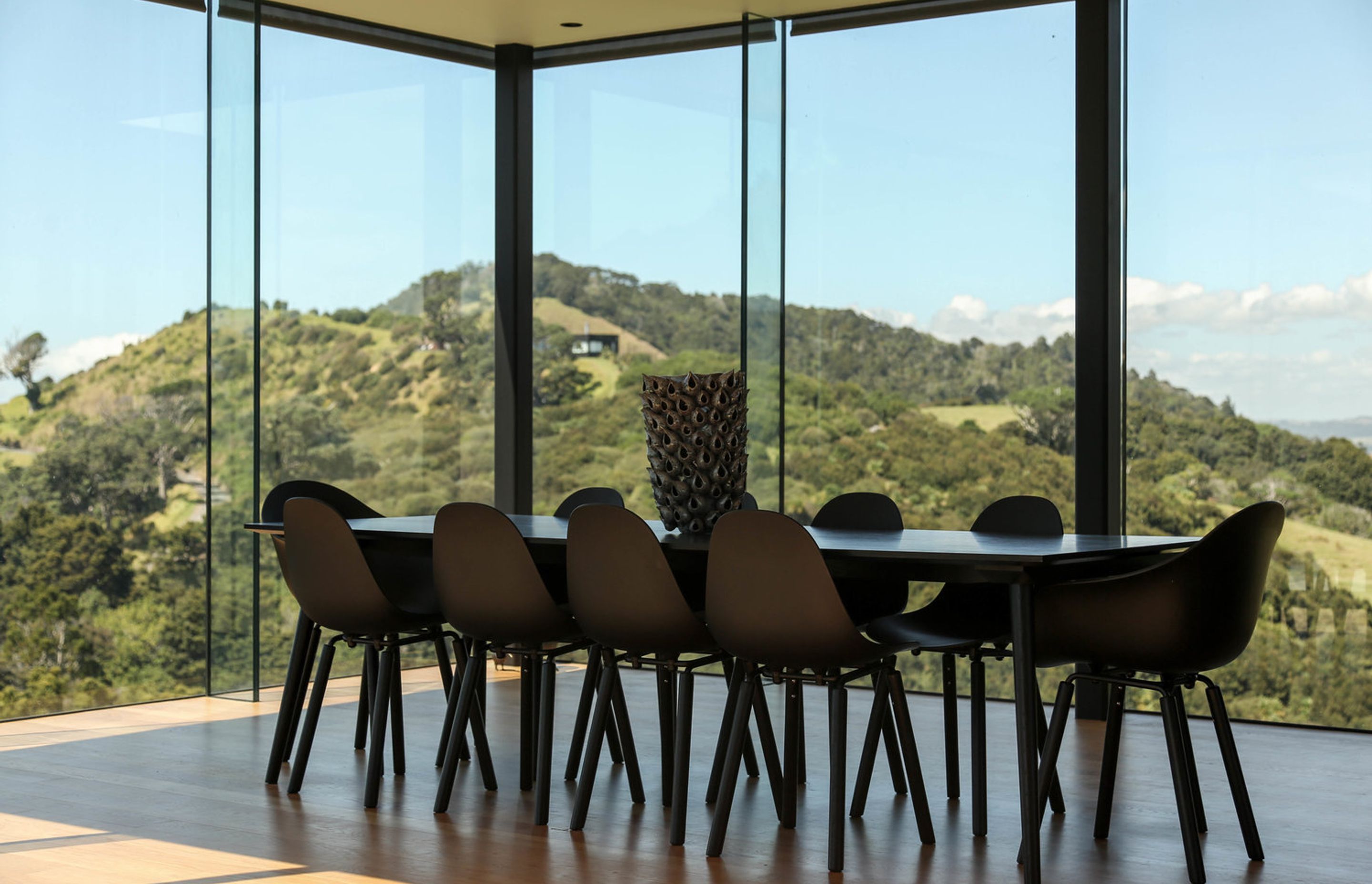 The dining area is fully glazed with views over the surrounding landscape.