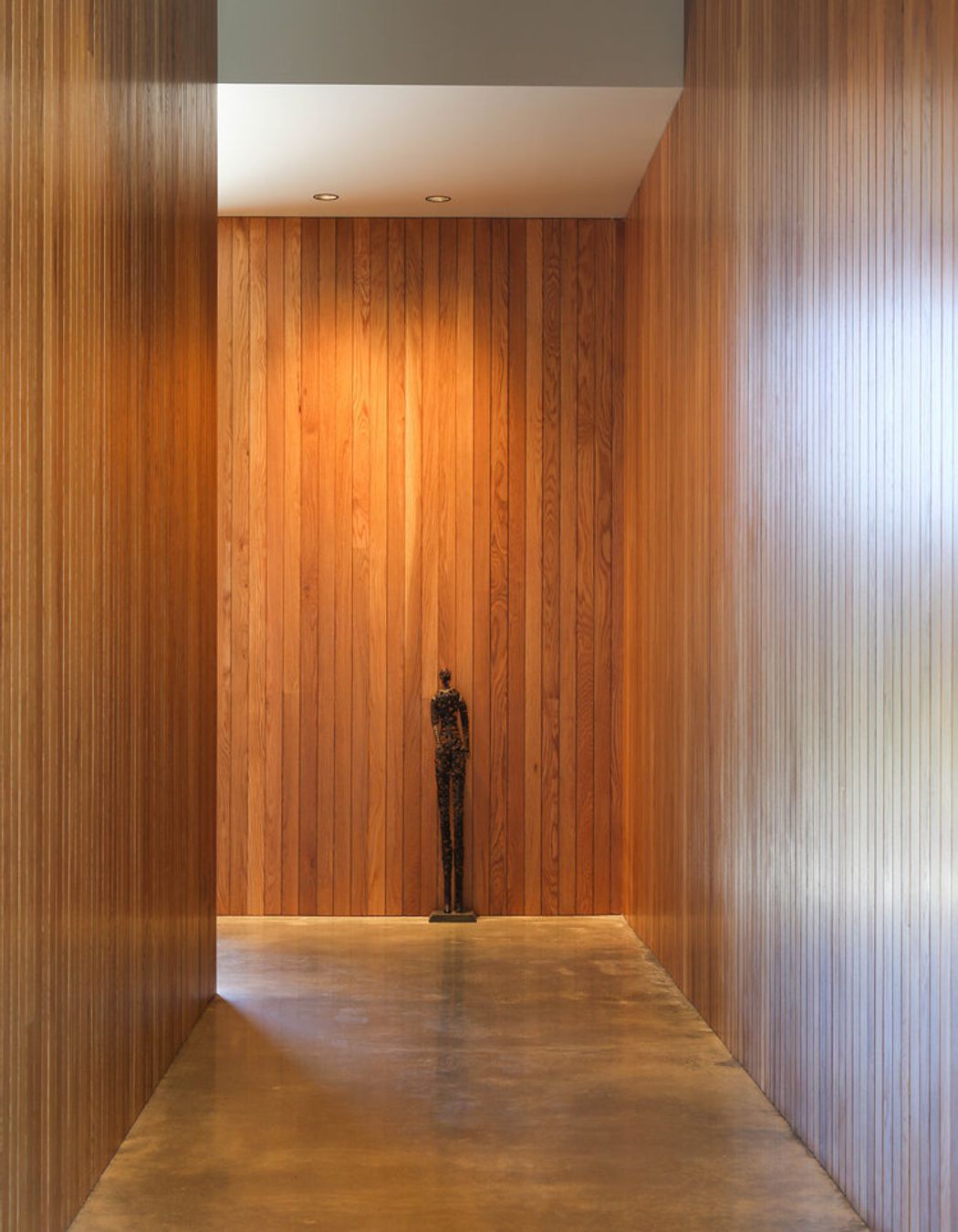 A timber -lined corridor also provides space for artworks.