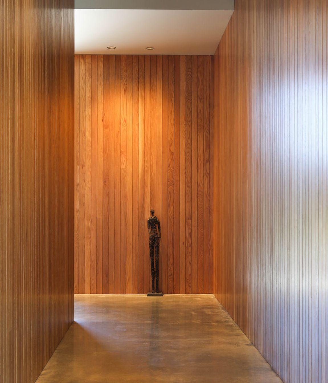 A timber -lined corridor also provides space for artworks.