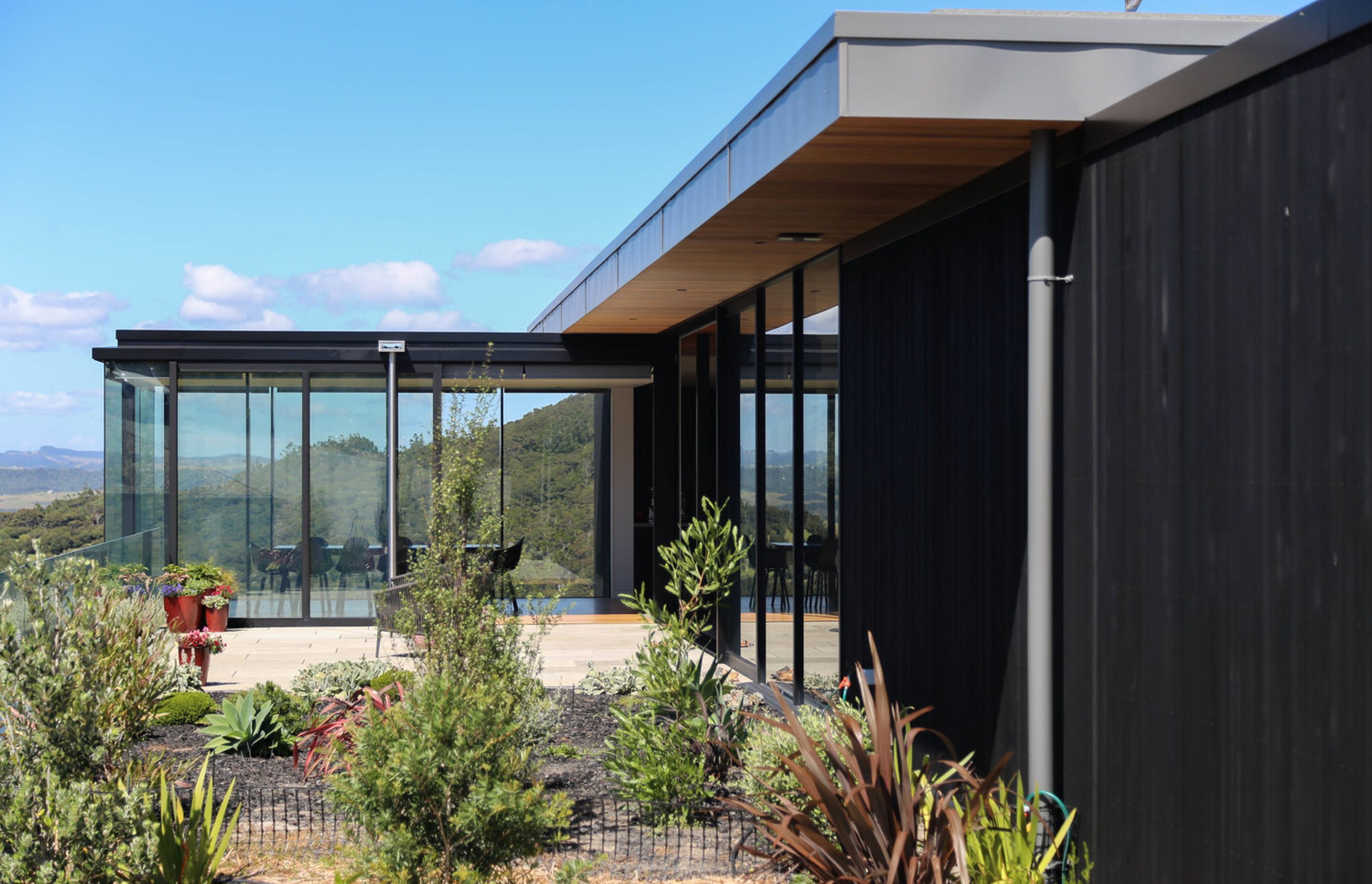 The glazed dining space seen through the newly landscaped garden and courtyard.