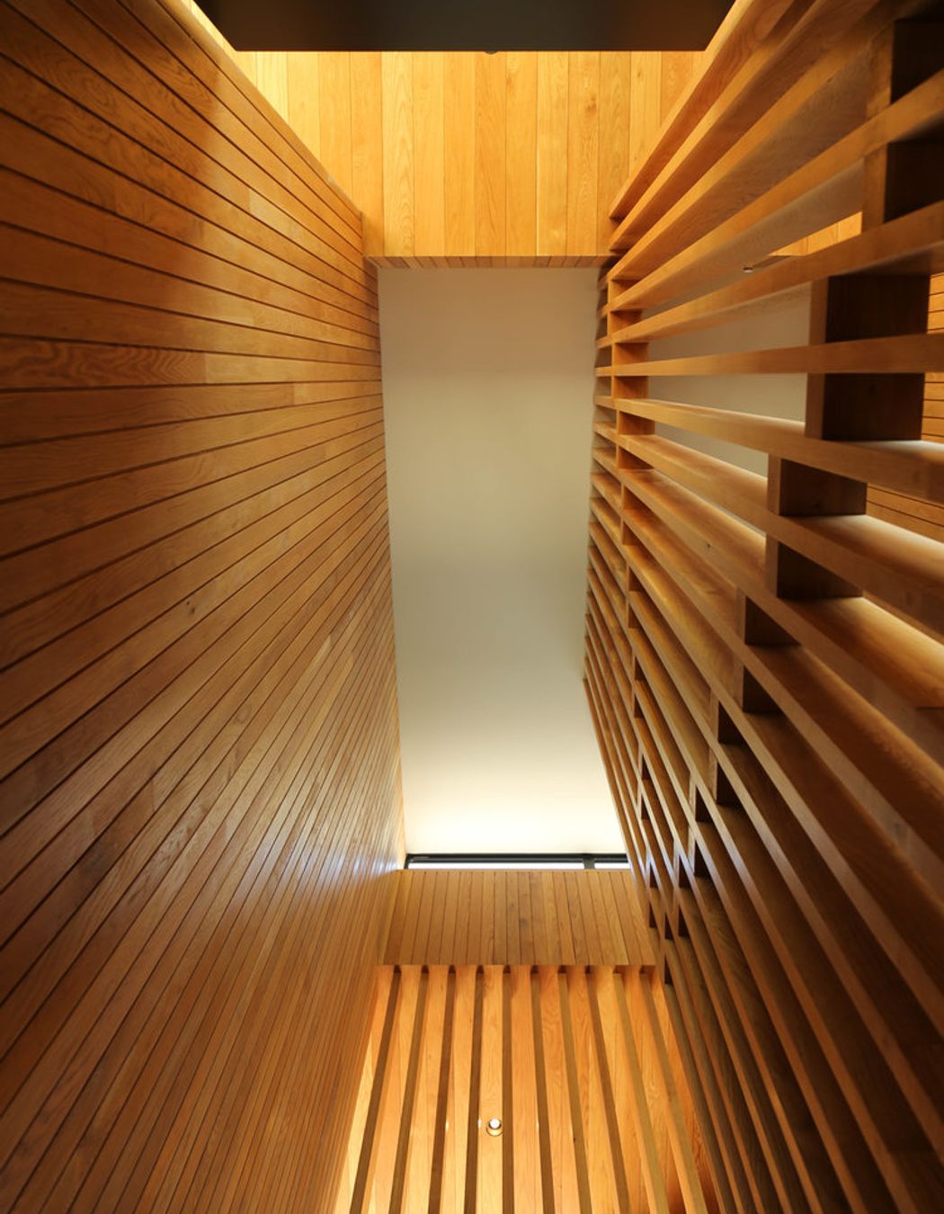 Looking up the 5m-high American oak timber staircase.