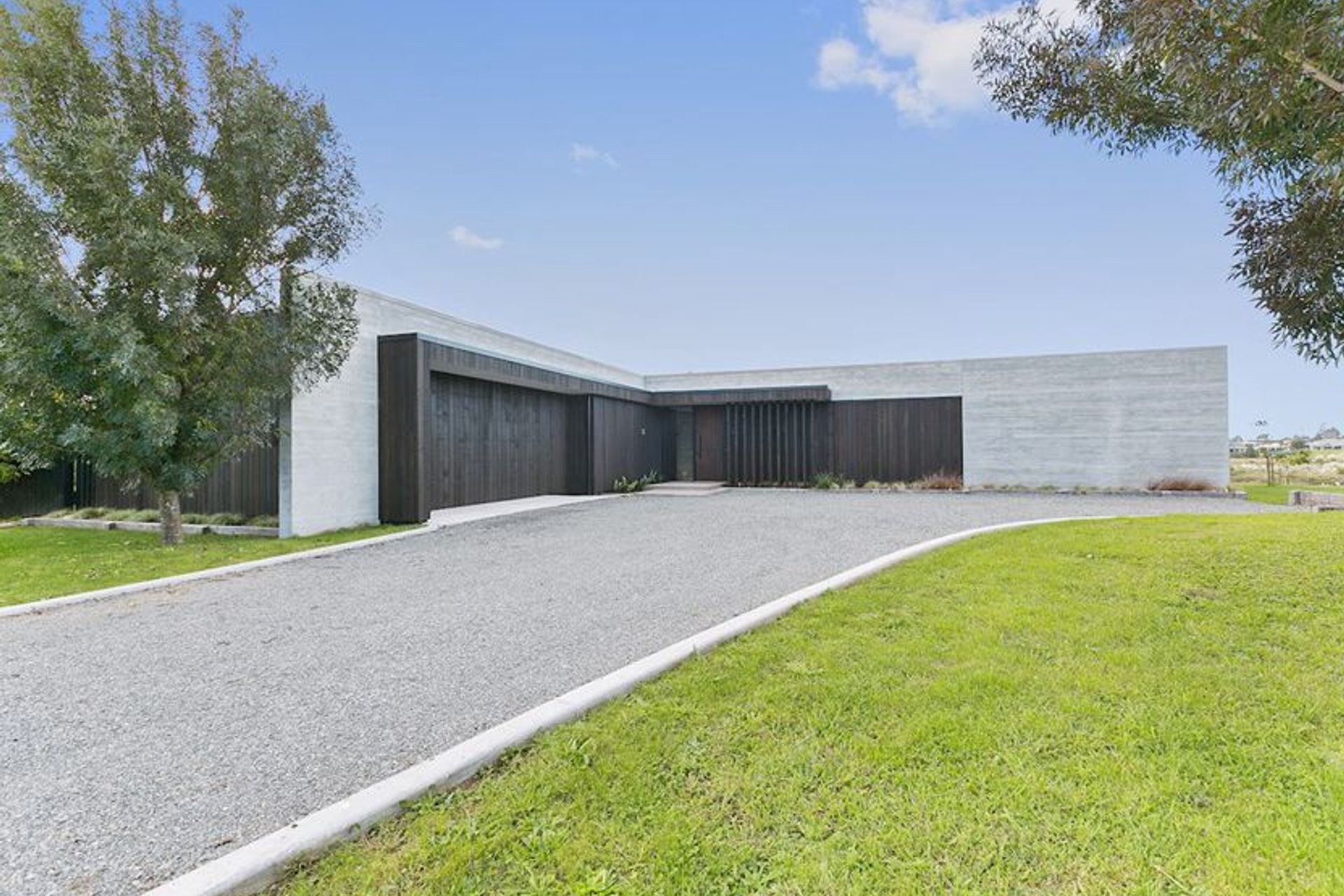 Clad in cedar and settled in a semi rural setting the spine of this ultra modern design is formed through perfectly executed insitu form poured concrete.  