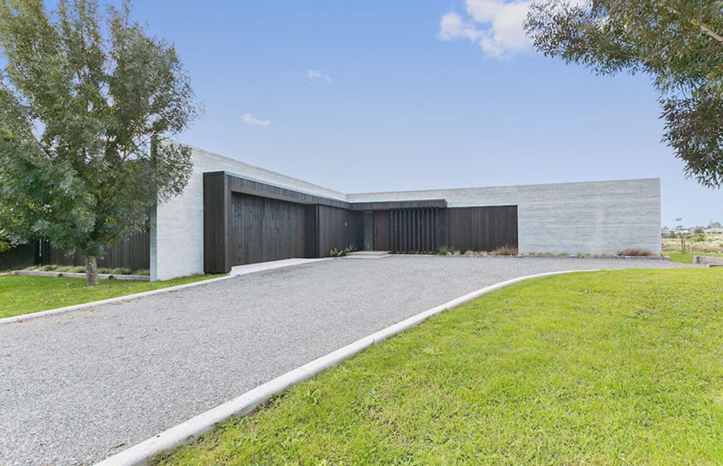 Clad in cedar and settled in a semi rural setting the spine of this ultra modern design is formed through perfectly executed insitu form poured concrete.  