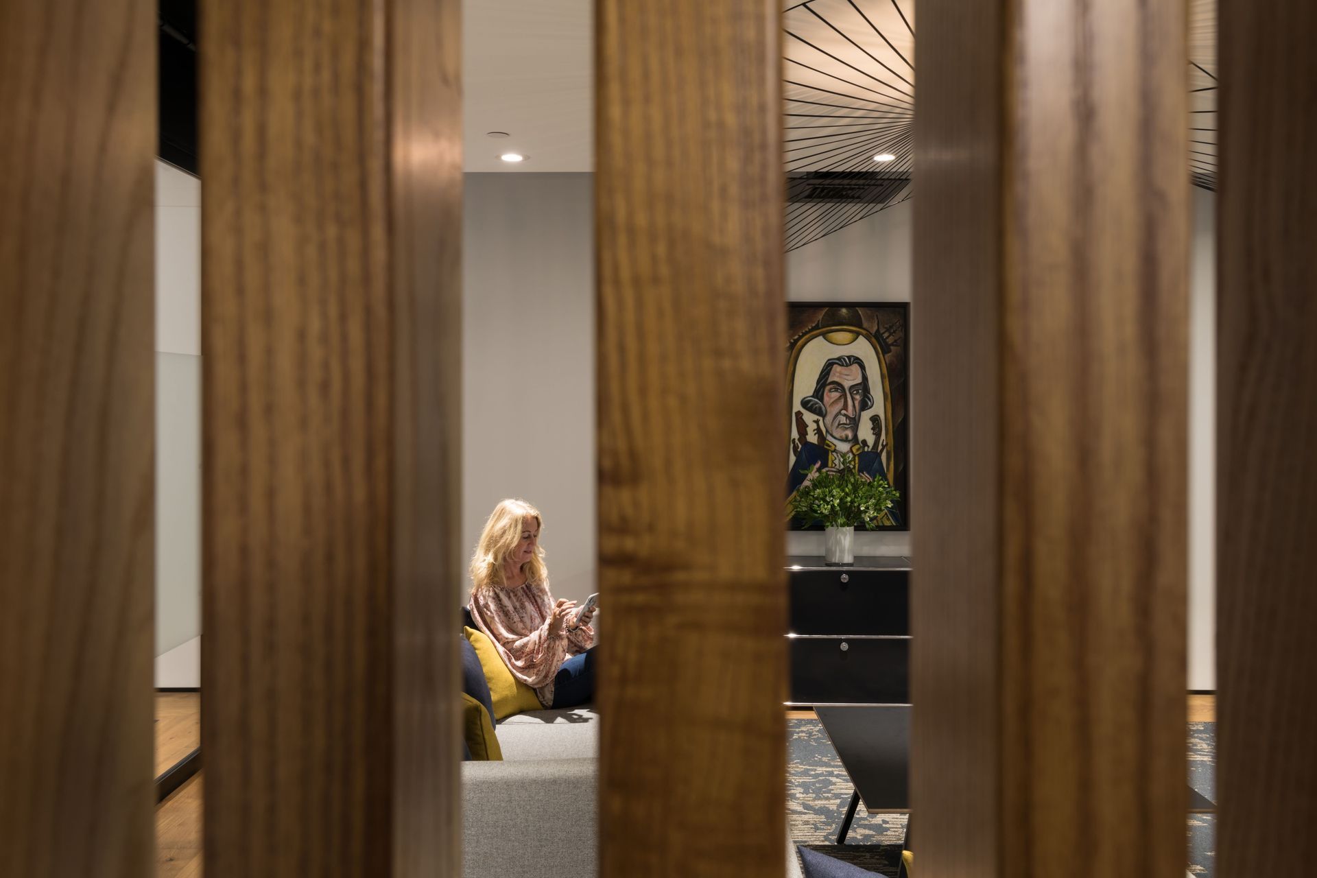 Wood batten screens allow for visual connection from the workspace while maintaining physical separation form the reception lounge