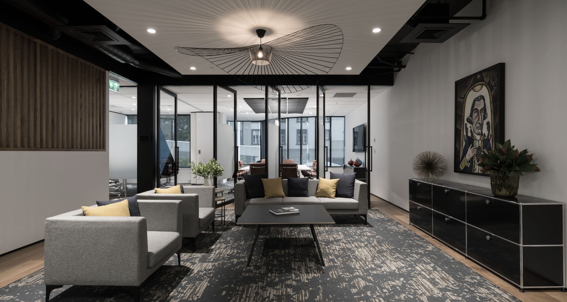 Reception lounge with feature carpet and wood frame flooring, with an operable wall to separate, or join, flexible meeting spaces beyond