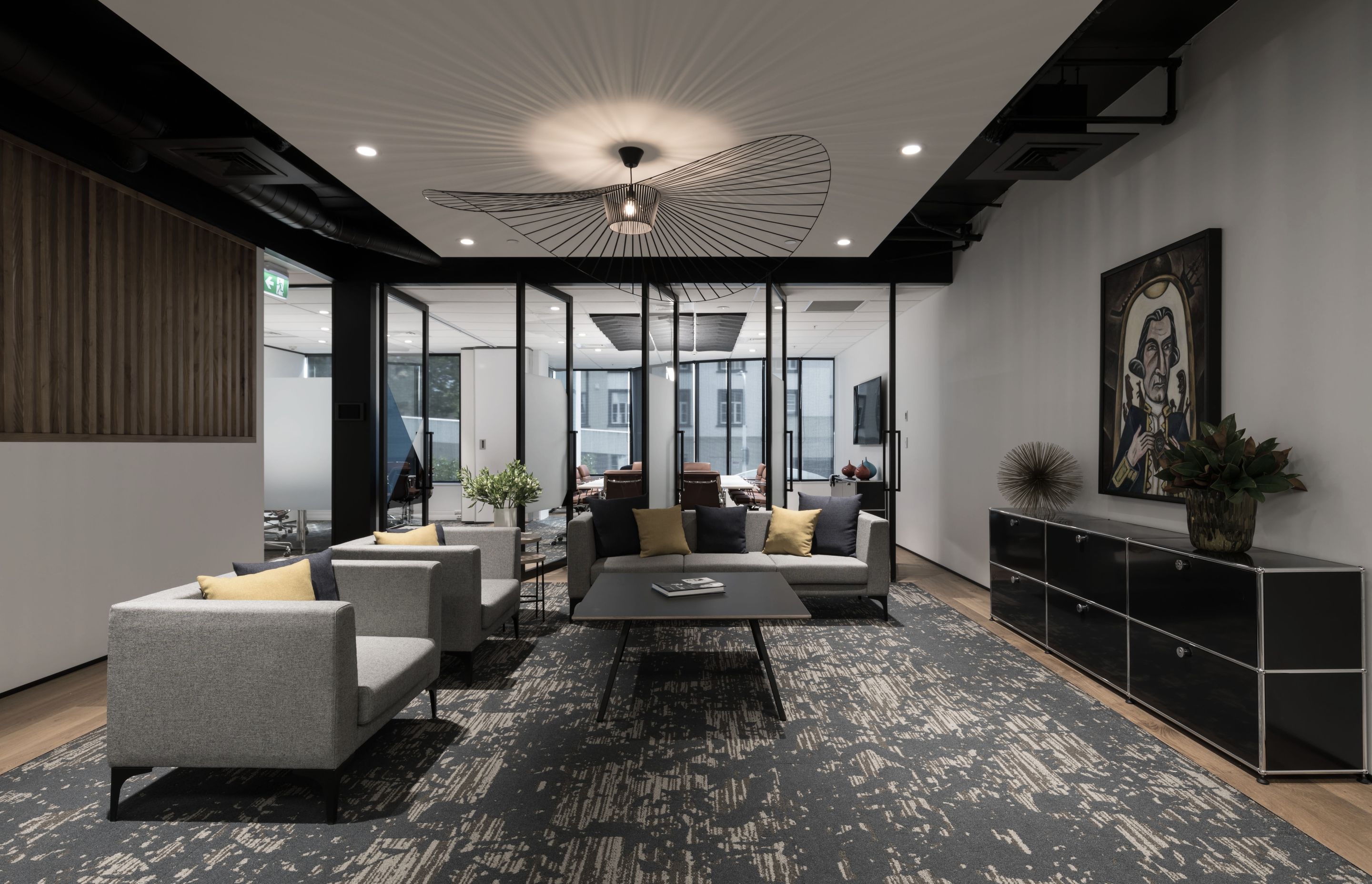 Reception lounge with feature carpet and wood frame flooring, with an operable wall to separate, or join, flexible meeting spaces beyond