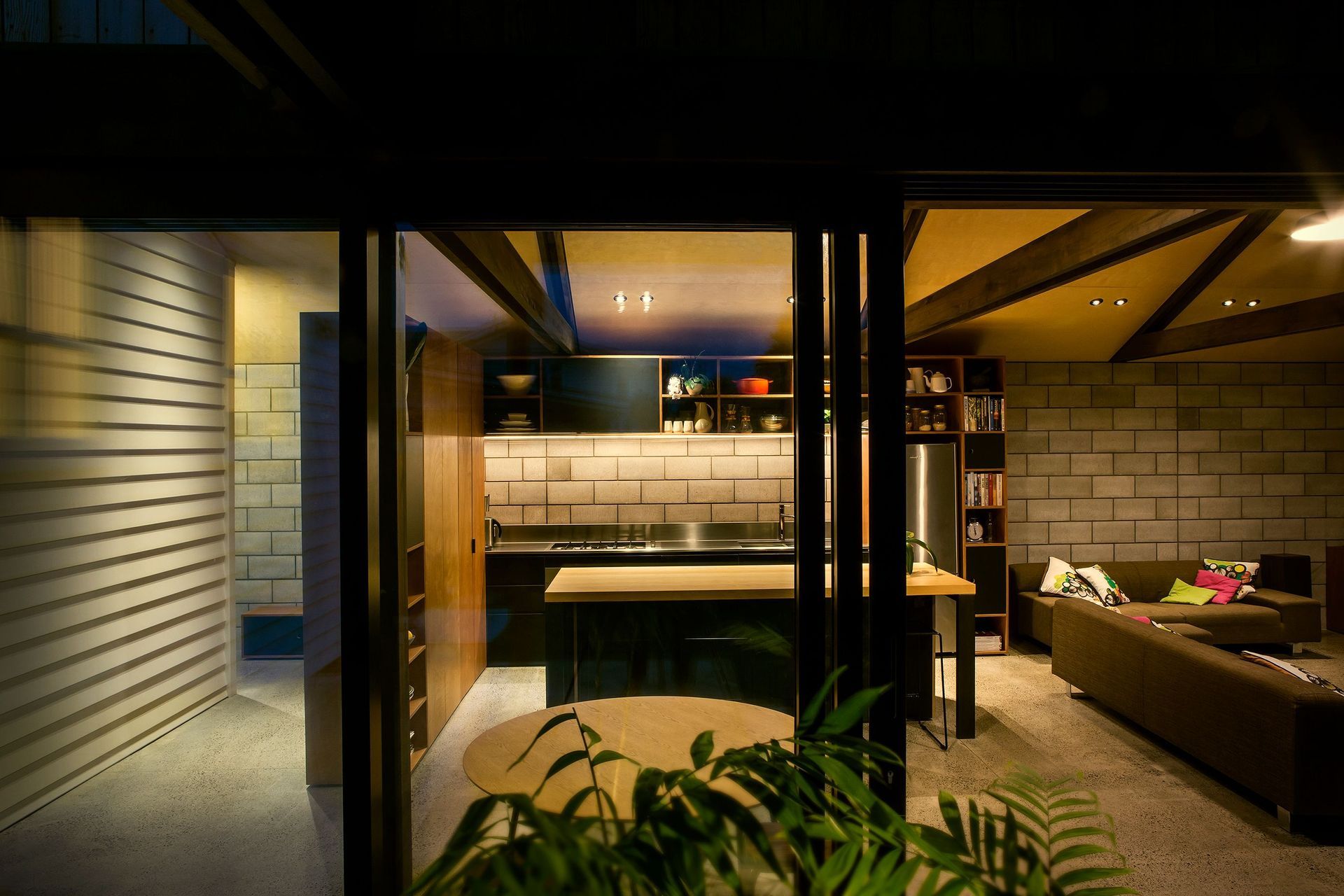 This standard bungalow on a standard quarter-acre section had the standard problems of its era: rooms oriented by rote and no connection to the backyard. A gabled roof that rose five metres at its apex made the dwelling look tall and blunt, rather l