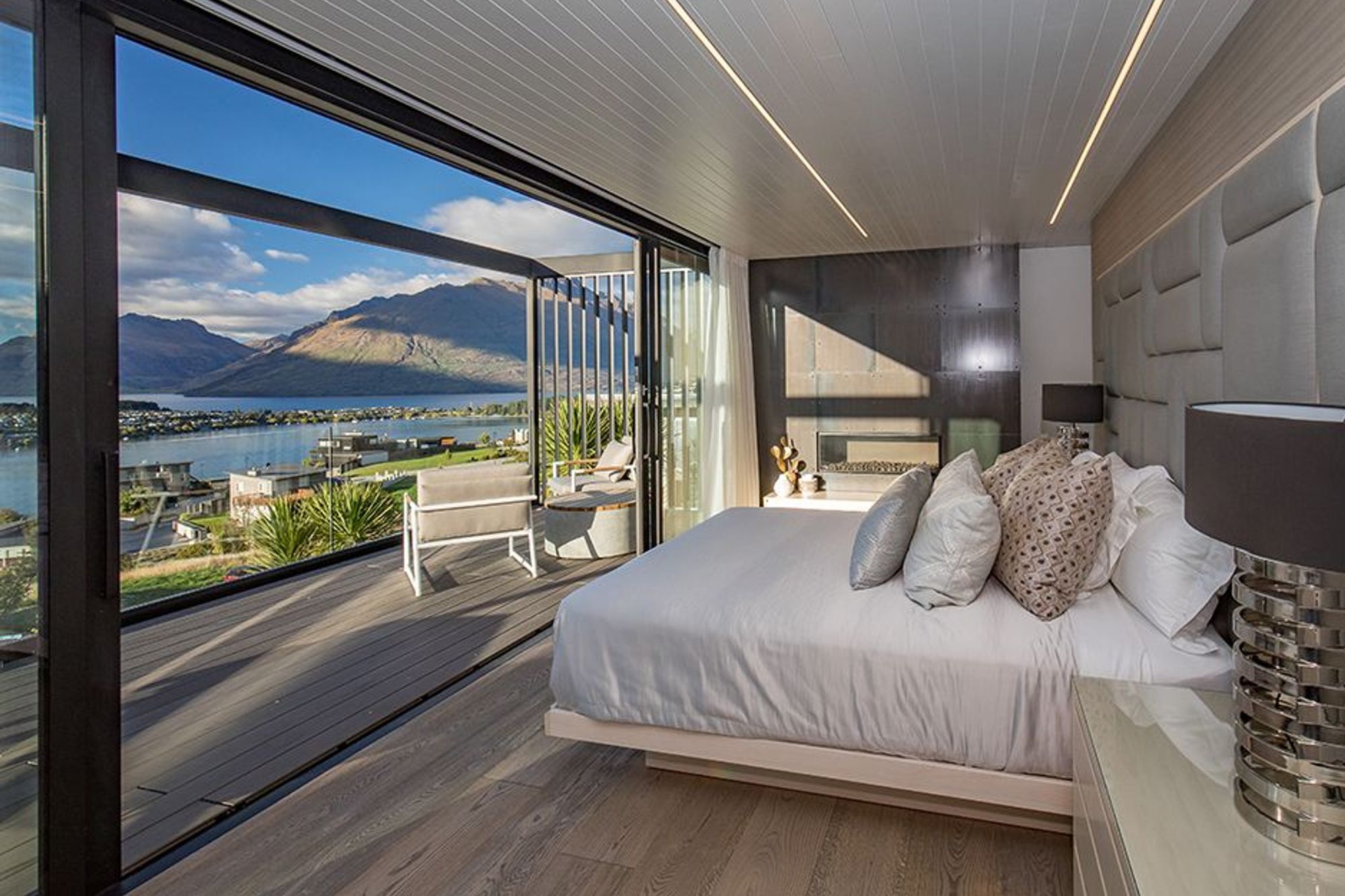 The bedroom has its own private deck area overlooking the lake and mountains, and a locally sourced gas fireplace that creates a cosy atmosphere during cooler weather.