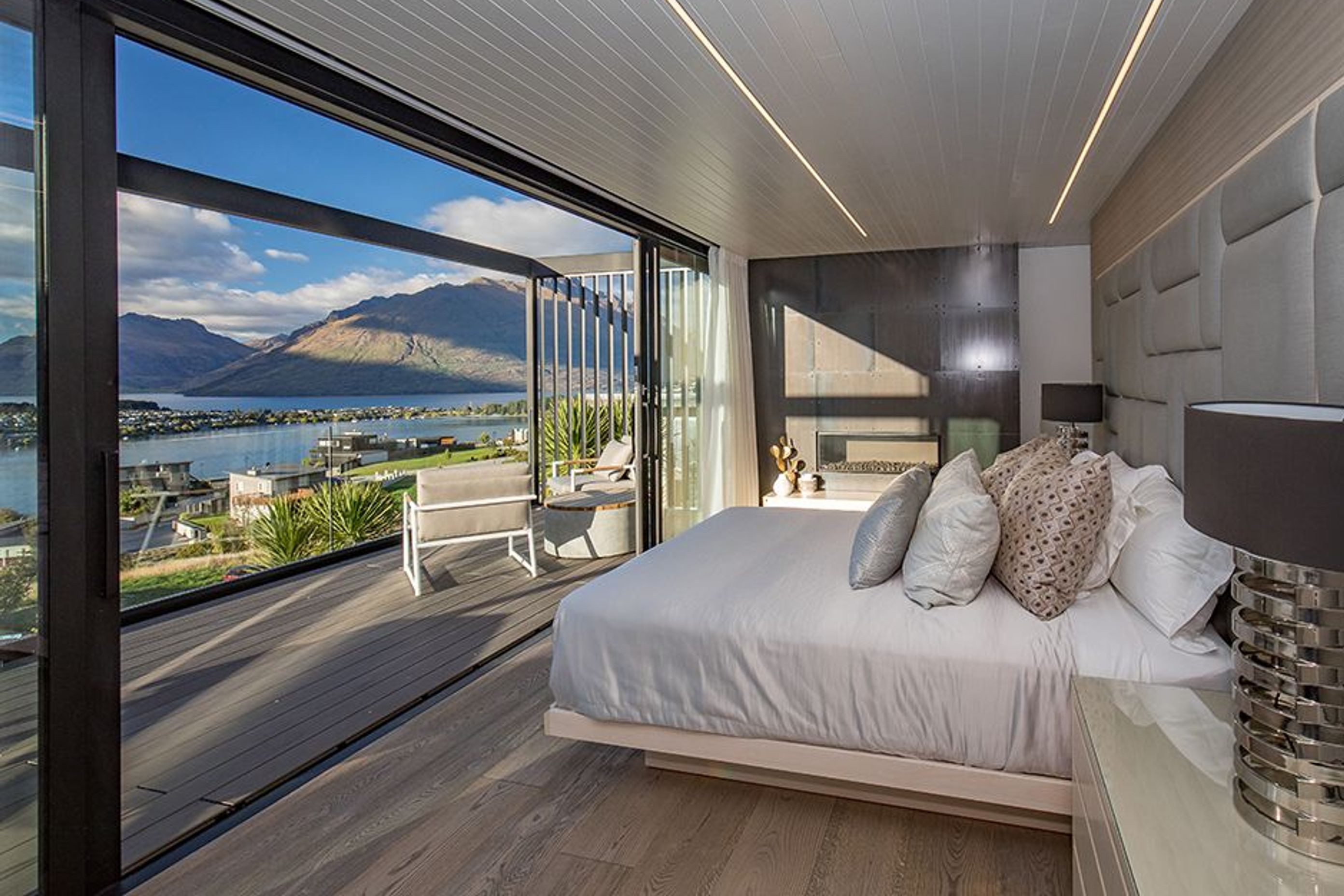 The bedroom has its own private deck area overlooking the lake and mountains, and a locally sourced gas fireplace that creates a cosy atmosphere during cooler weather.