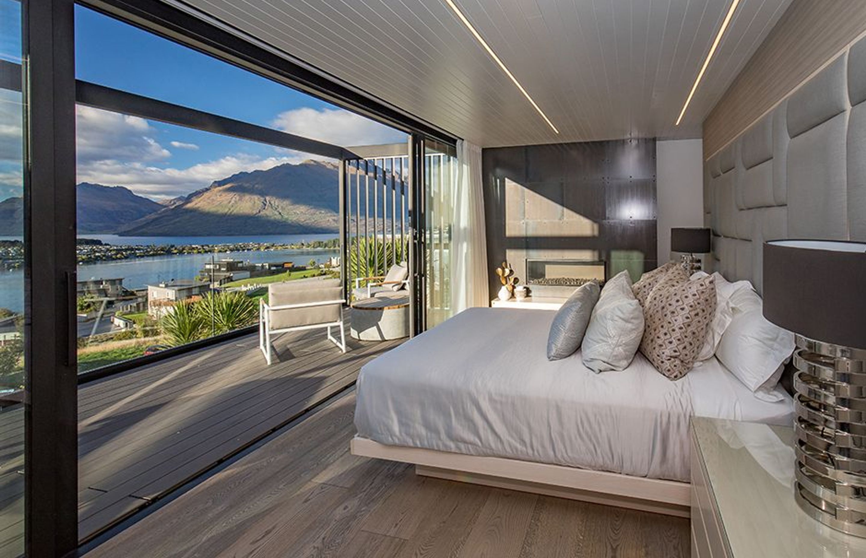 The bedroom has its own private deck area overlooking the lake and mountains, and a locally sourced gas fireplace that creates a cosy atmosphere during cooler weather.