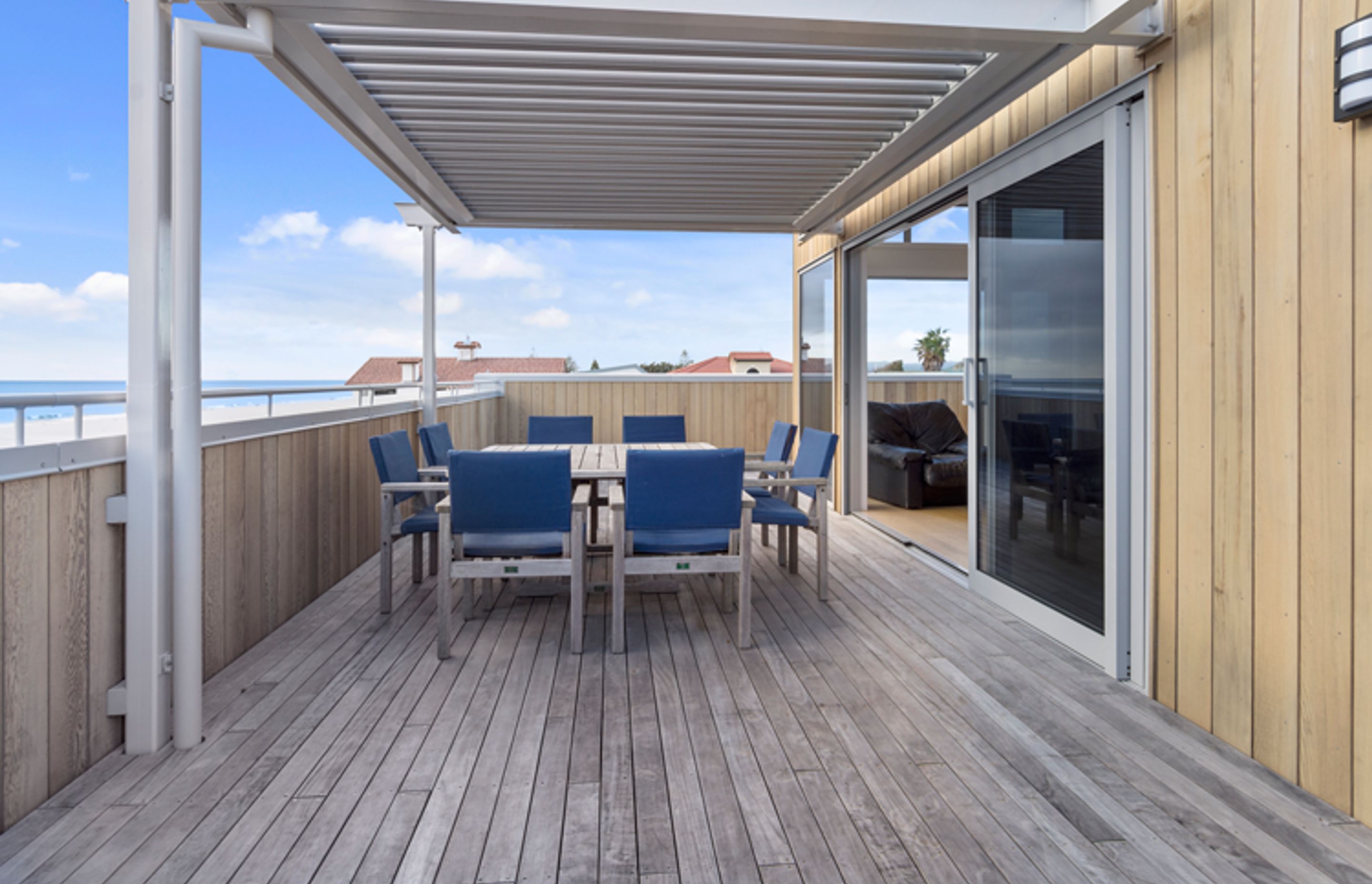 The Glass sliders connecting the living space to the outdoor decking welcome in the sea air and open onto the alfresco dining space which is under the Louvretec roof. 