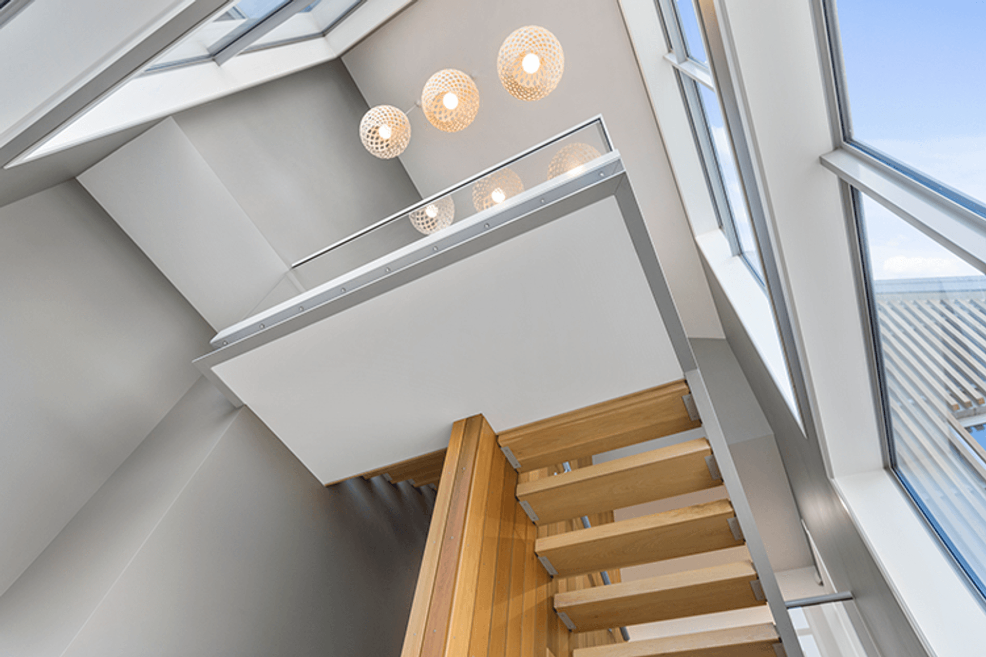 Cedar carries into the interior, featured in the suspended floating staircase with exposed steel and glass framing.