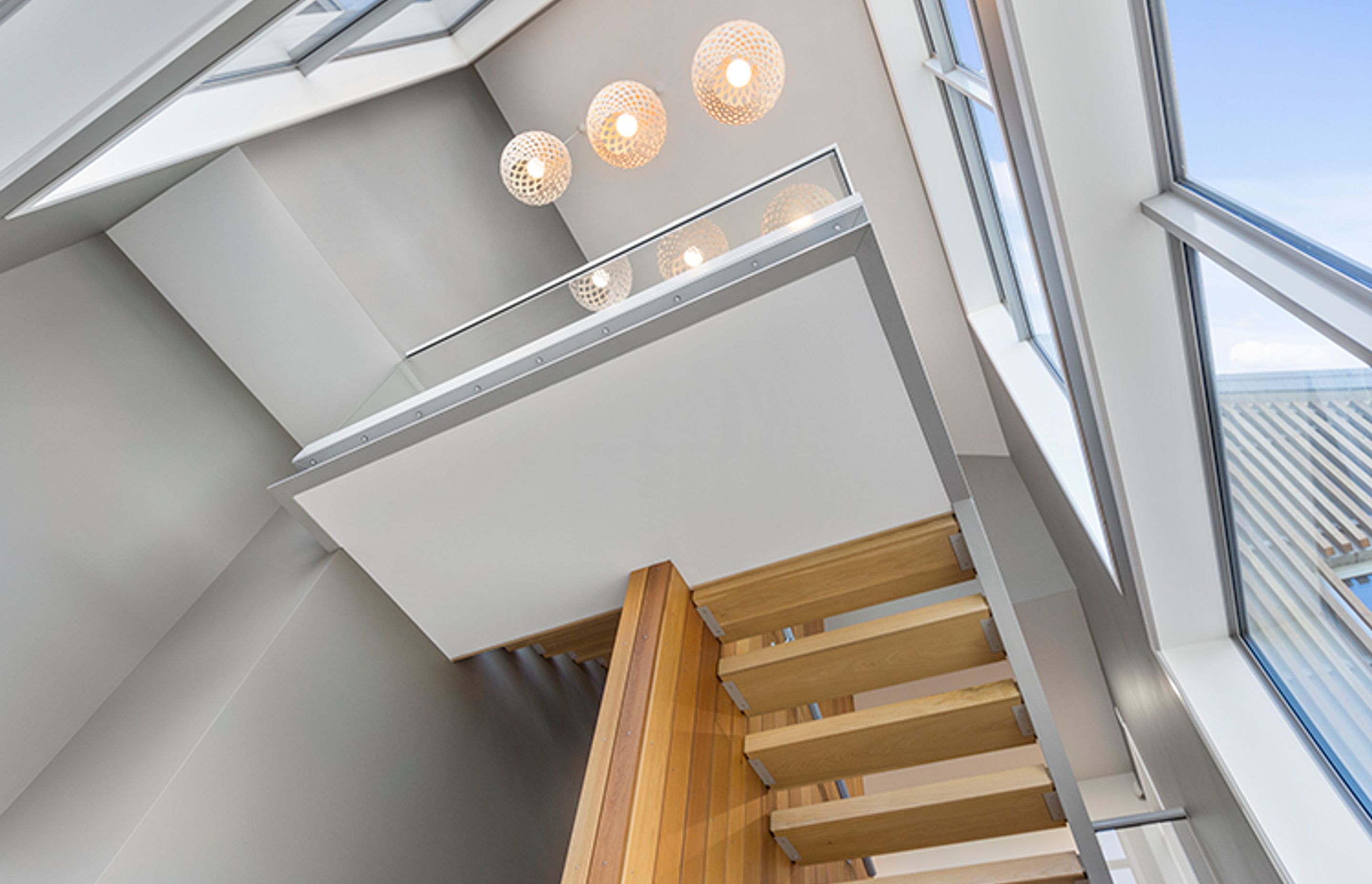 Cedar carries into the interior, featured in the suspended floating staircase with exposed steel and glass framing.