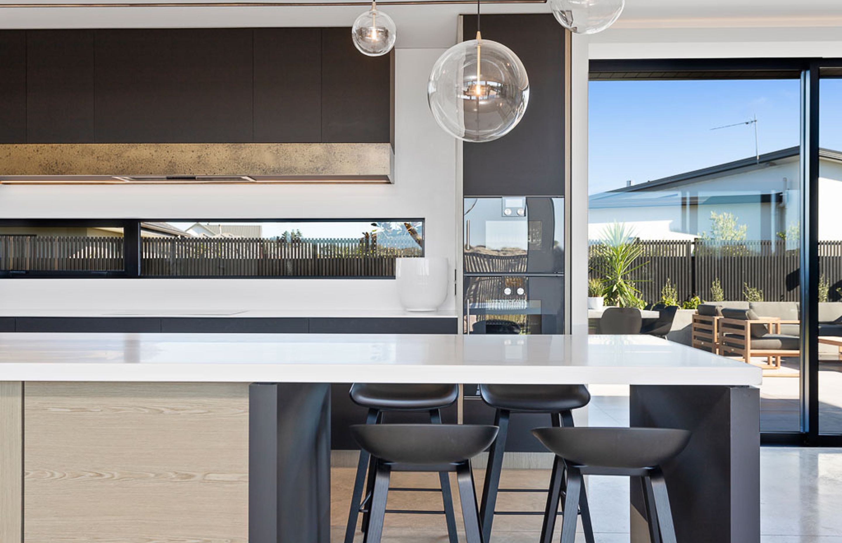 The mix of white and neutral tones and varying materials gives the kitchen a tactile, yet grounded feel.