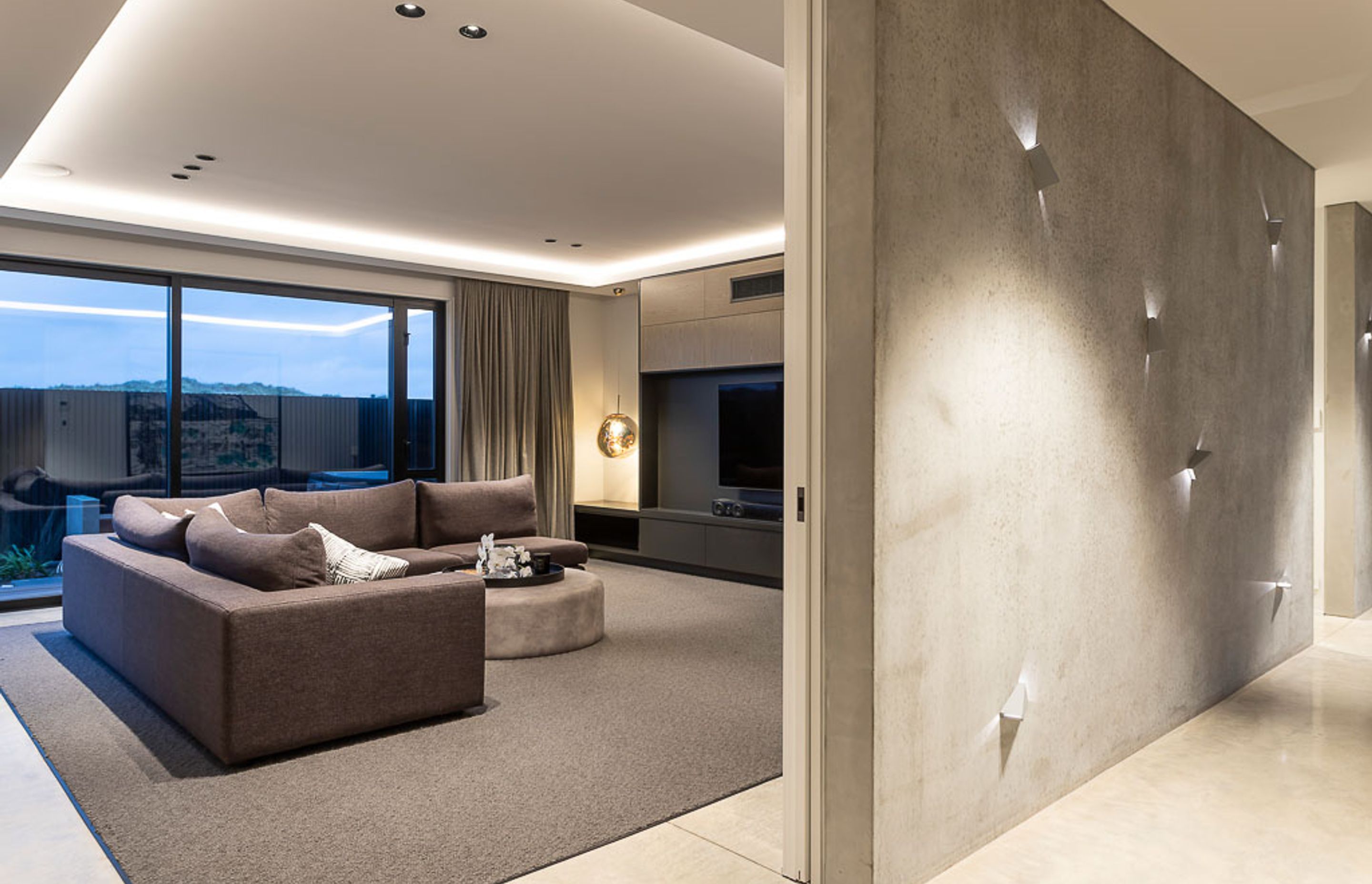 The textured entry wall with lighting feature, and the formal lounge on the ground floor.