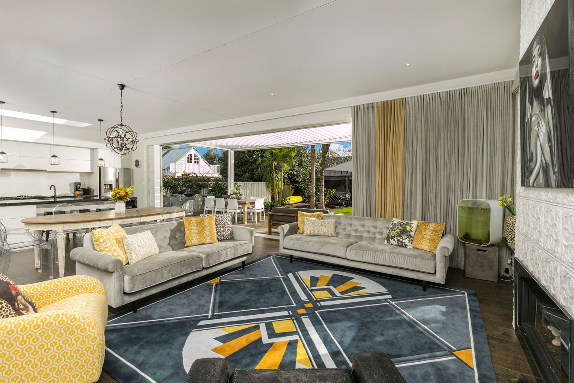 Bold accent of yellow connected the living area, the custom designed rug harked back to a Deco era, and the fireplace faced and kitchen splashback, connected with the Victorian era.