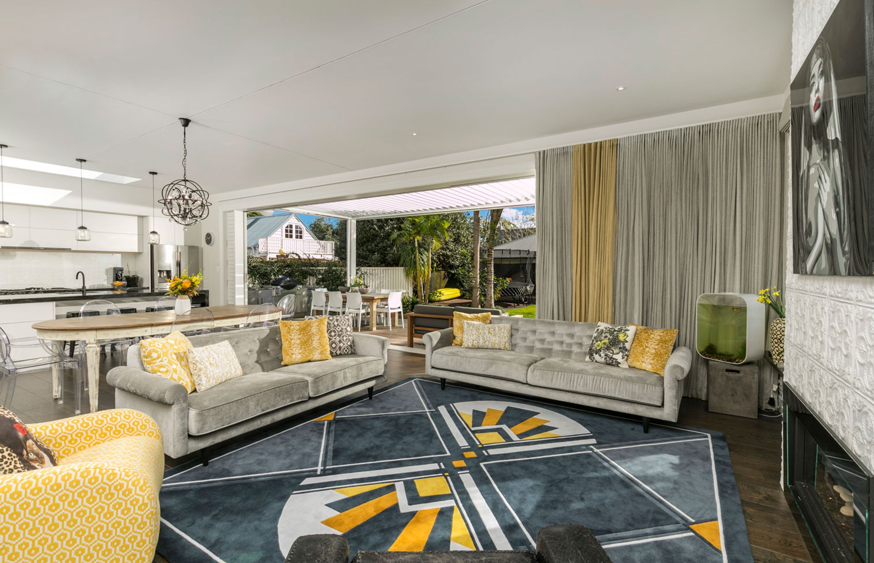 Bold accent of yellow connected the living area, the custom designed rug harked back to a Deco era, and the fireplace faced and kitchen splashback, connected with the Victorian era.